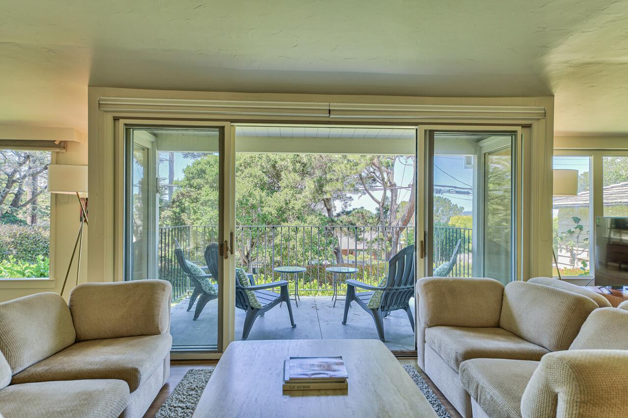 Sliding Doors Lead to Elevated Covered Deck with Garden View