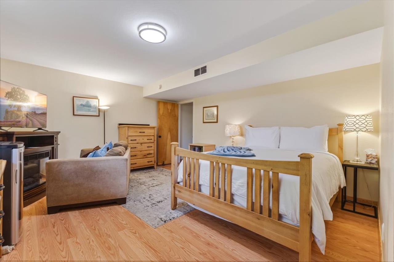 Bedroom 2, Queen Bed, TV and Seating Area