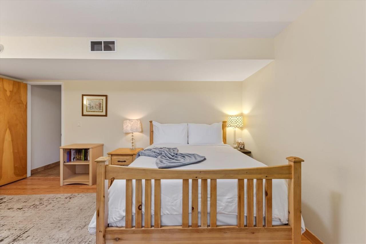 Bedroom 2, Queen Bed, TV and Seating Area