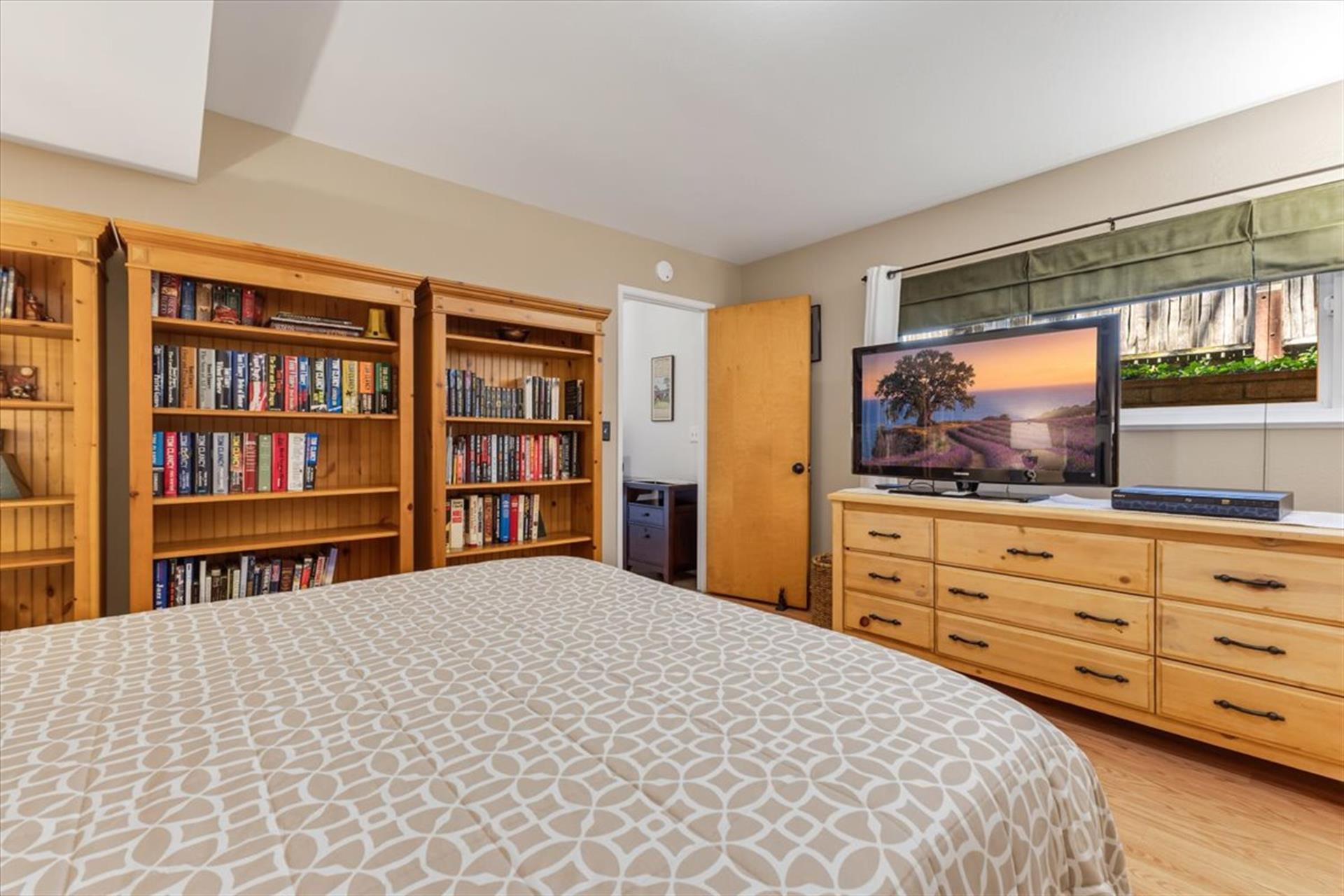 Bedroom 3, Queen Bed, TV and a Library of Books