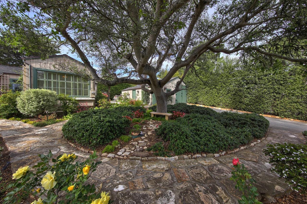 Stone Patios and Paths and A Lush Garden Surround the Home