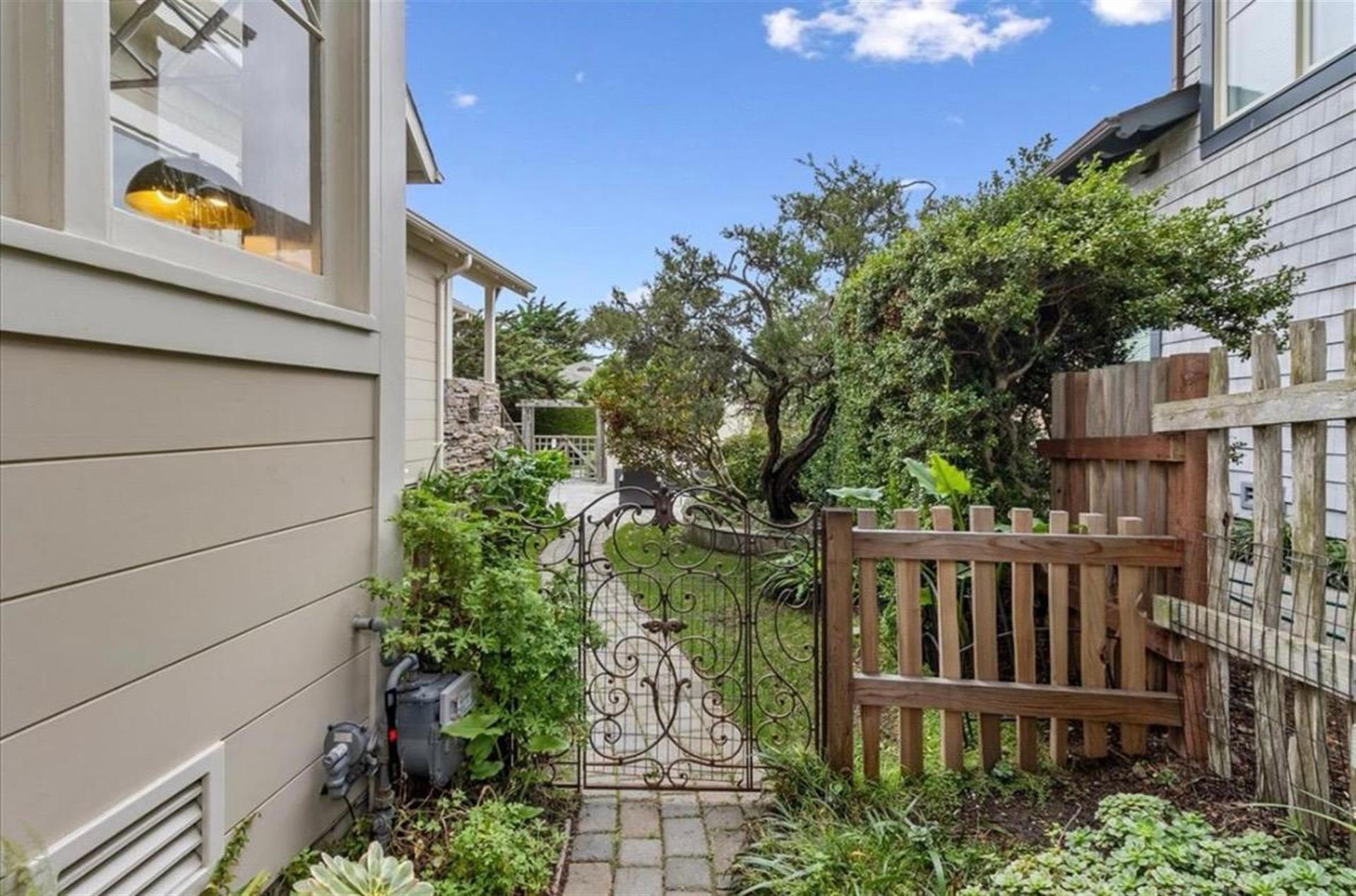Artistic Iron Gate Leads from the Backyard to the Front Yard