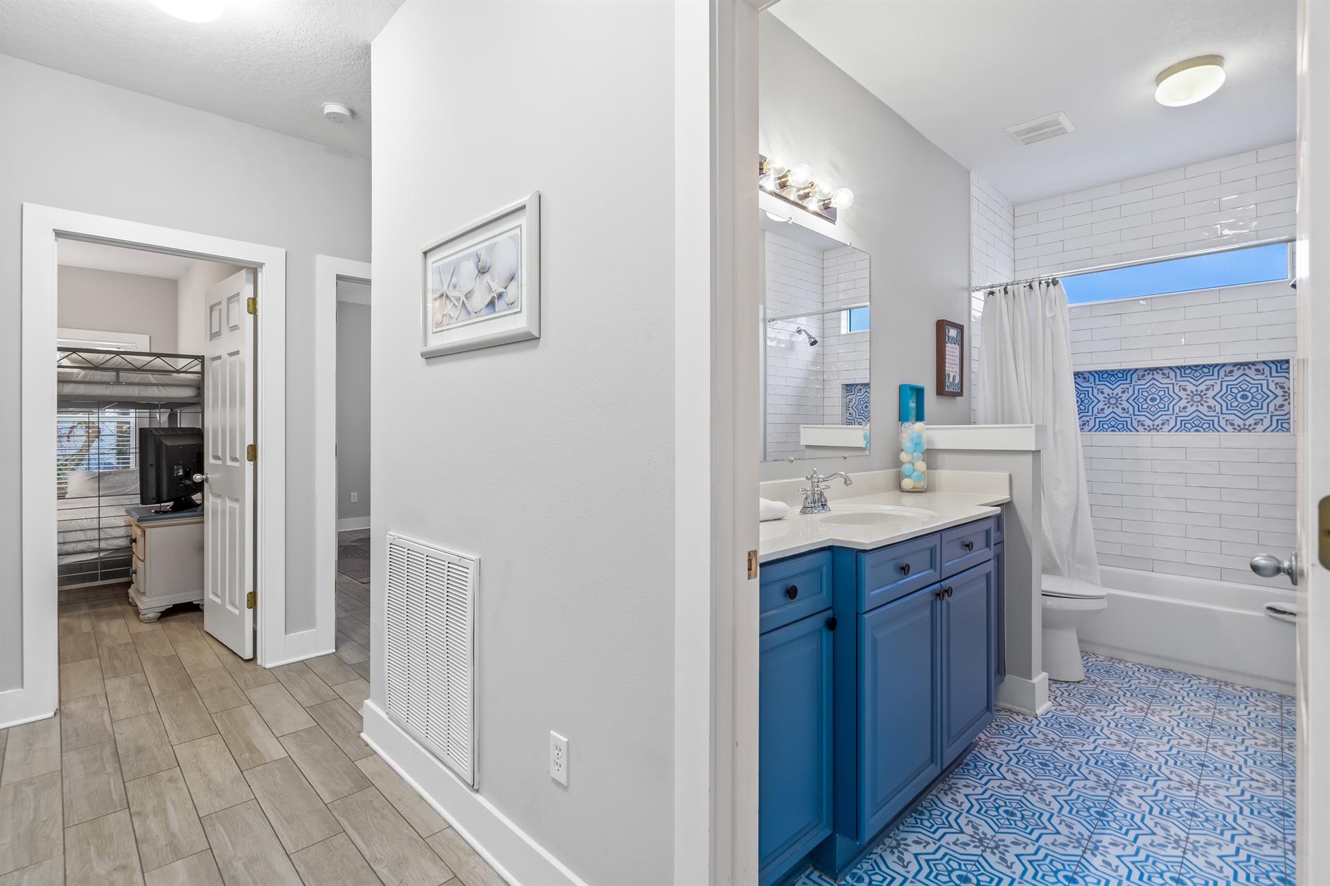 Another view from the hallway of the bathroom for the queen bedroom with a bathtubshower combination.