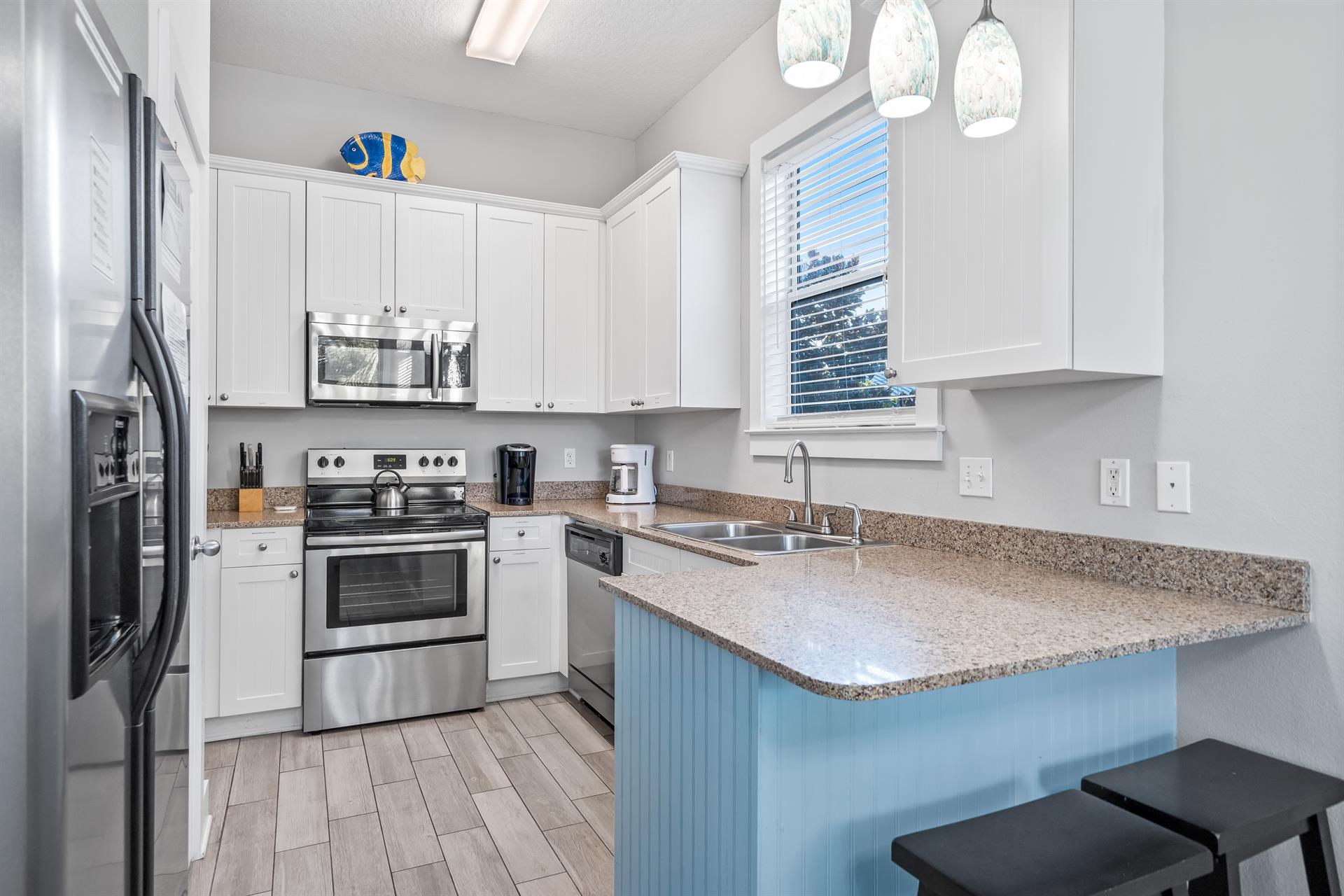 Fully Stocked Kitchen with Stainless Steel Appliances and Bar Seating for 2