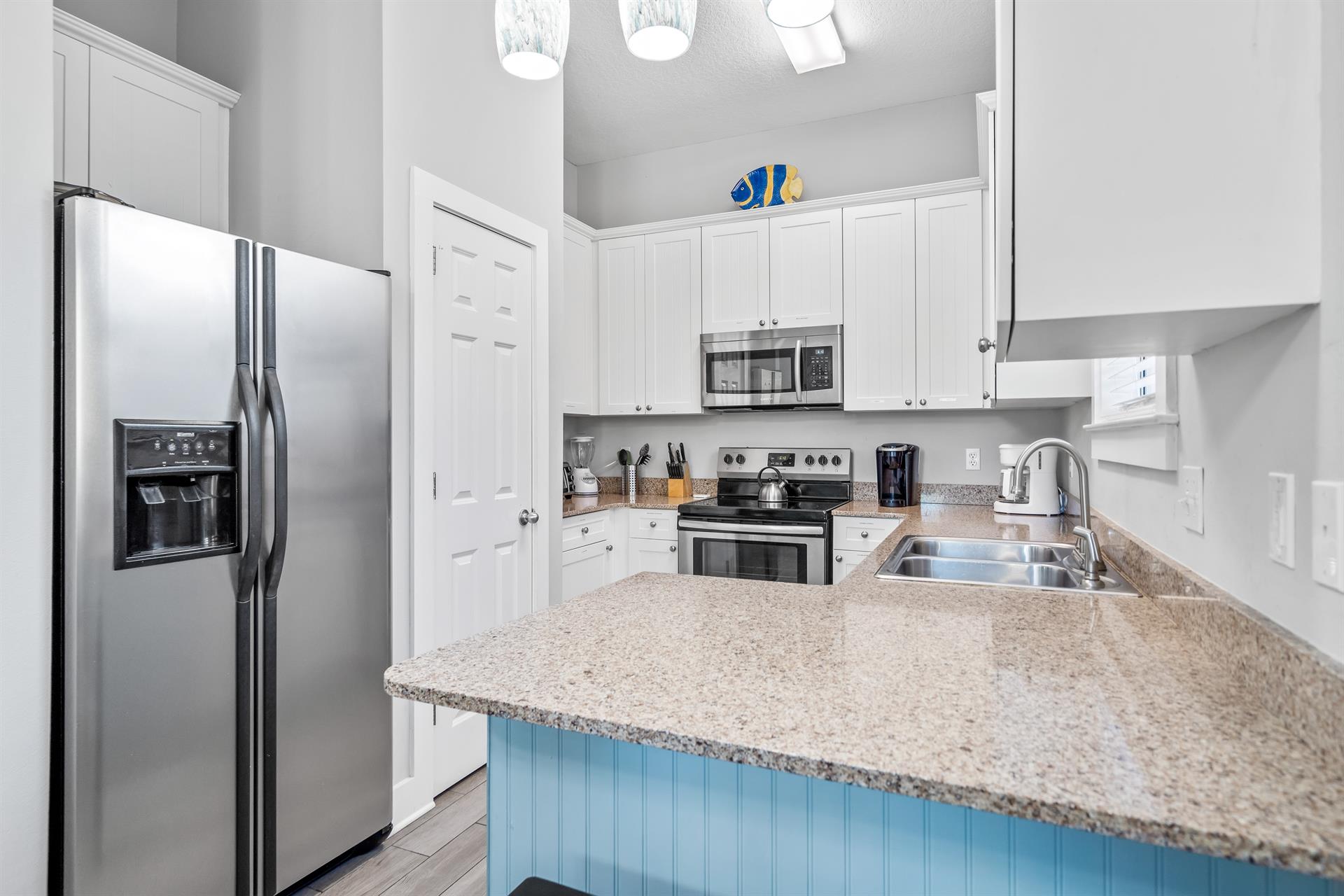 Fully Stocked Kitchen with Stainless Steel Appliances and Bar Seating for 2