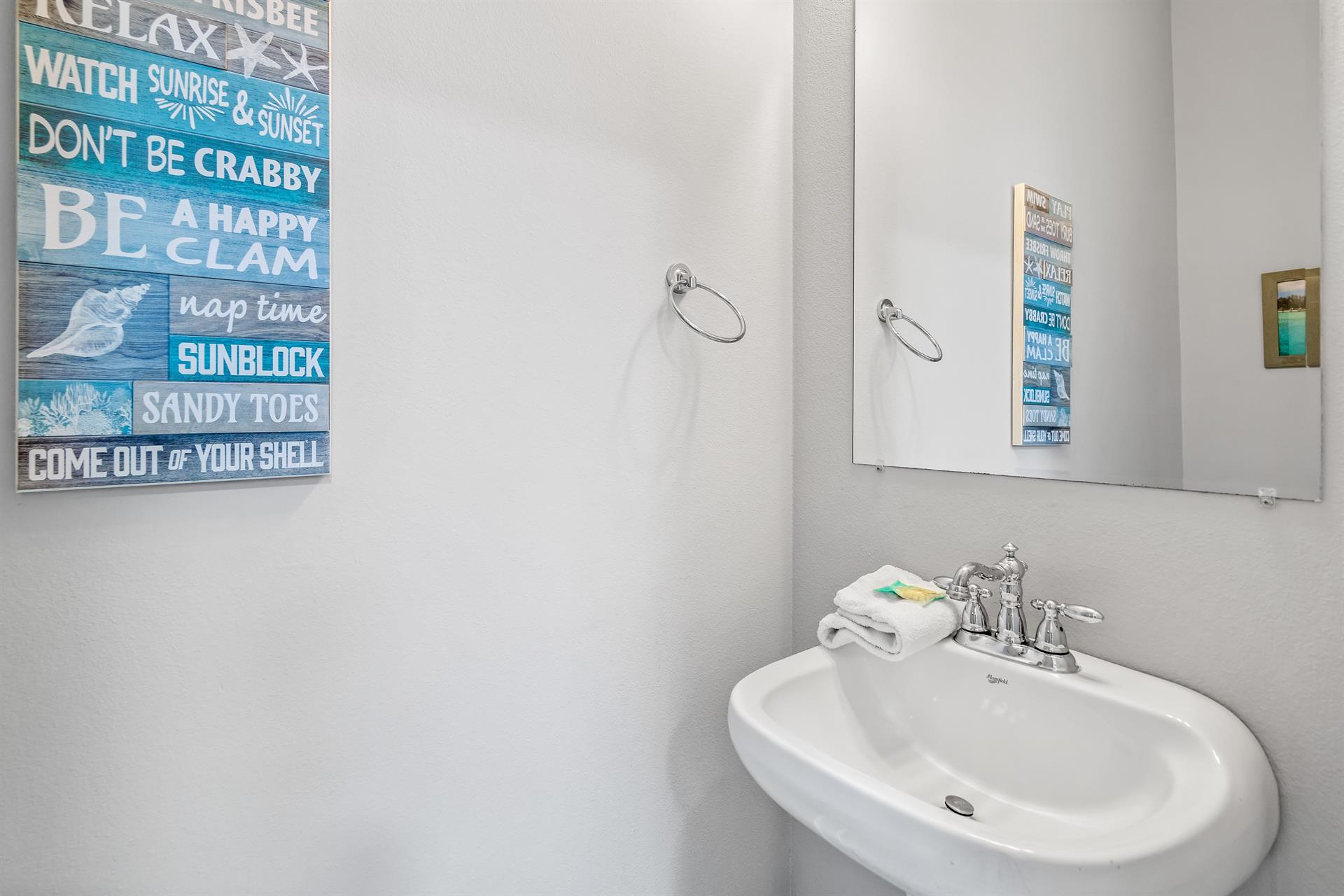 2nd floor half bathroom located in the hallway between the living area  primary bedroom.