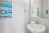 2nd floor half bathroom located in the hallway between the living area  primary bedroom.
