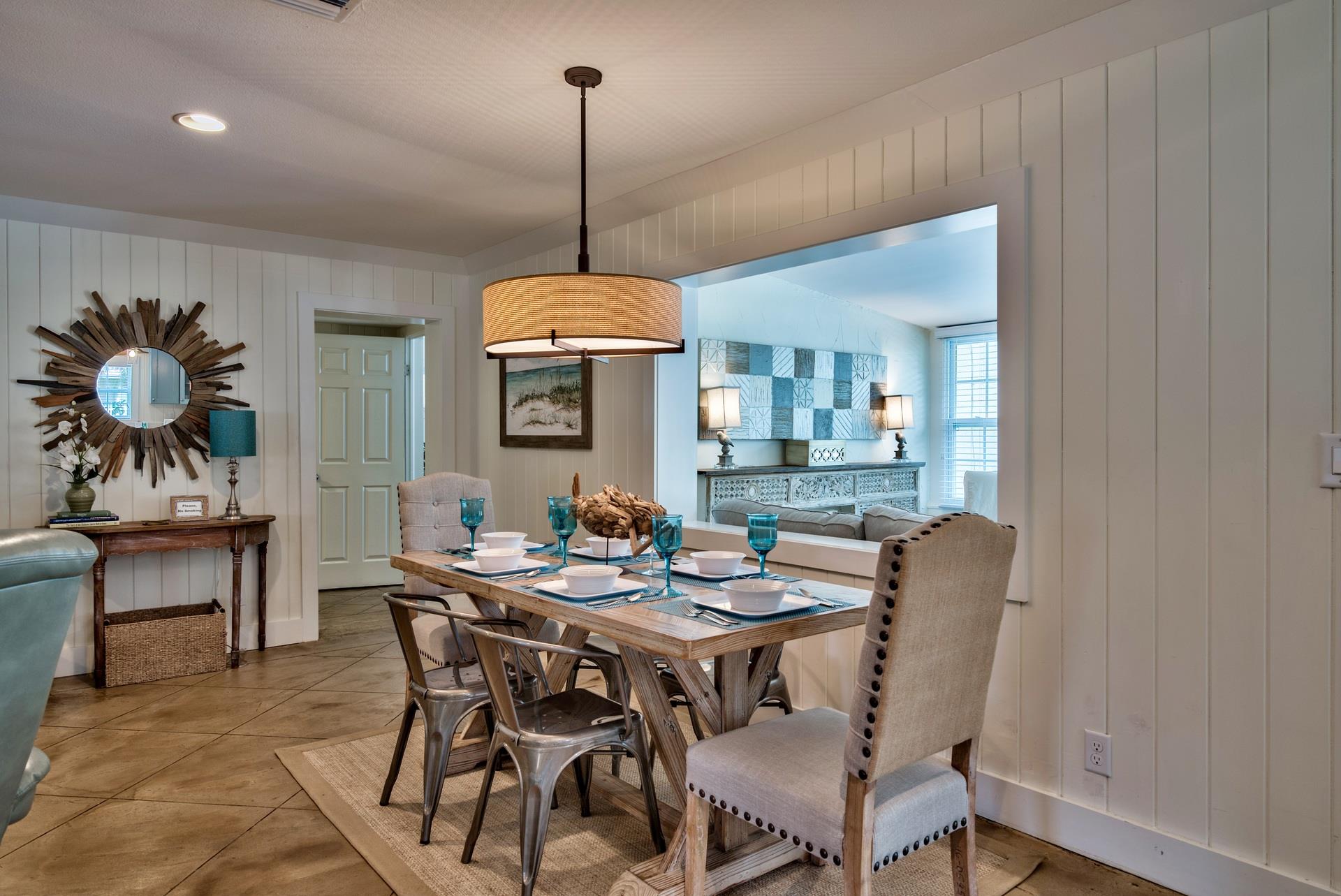 Dining Table Seats 6 with 2 Bar Seats Available in this Beachy Great Room  Professional Decor with Driftwood Accents Throughout.