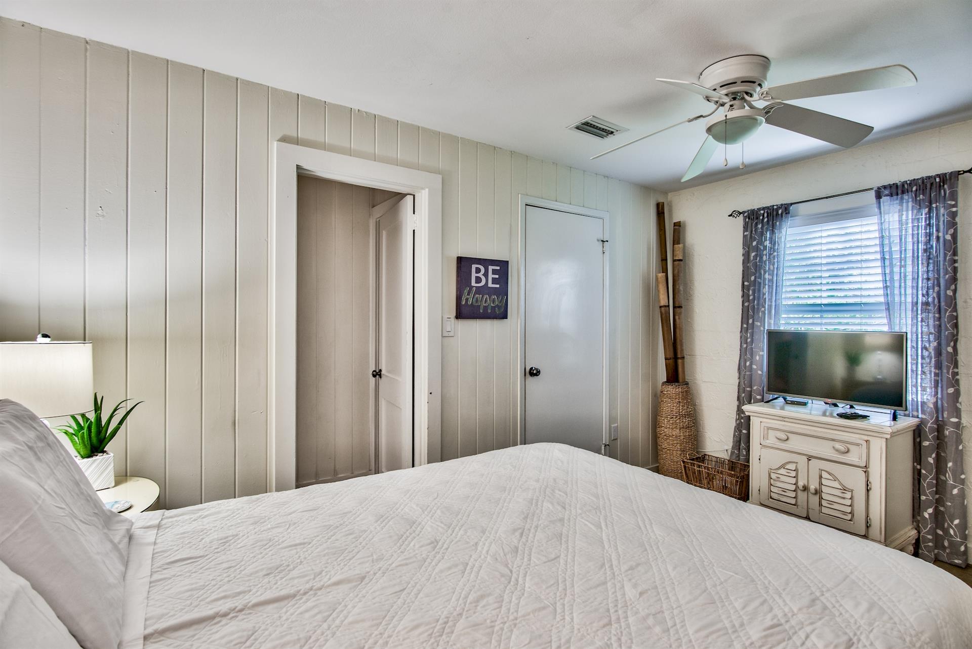 First bedroom on the west end of Seabreeze with queen bed, walkin closet,  adjacent full bathroom with walkin shower