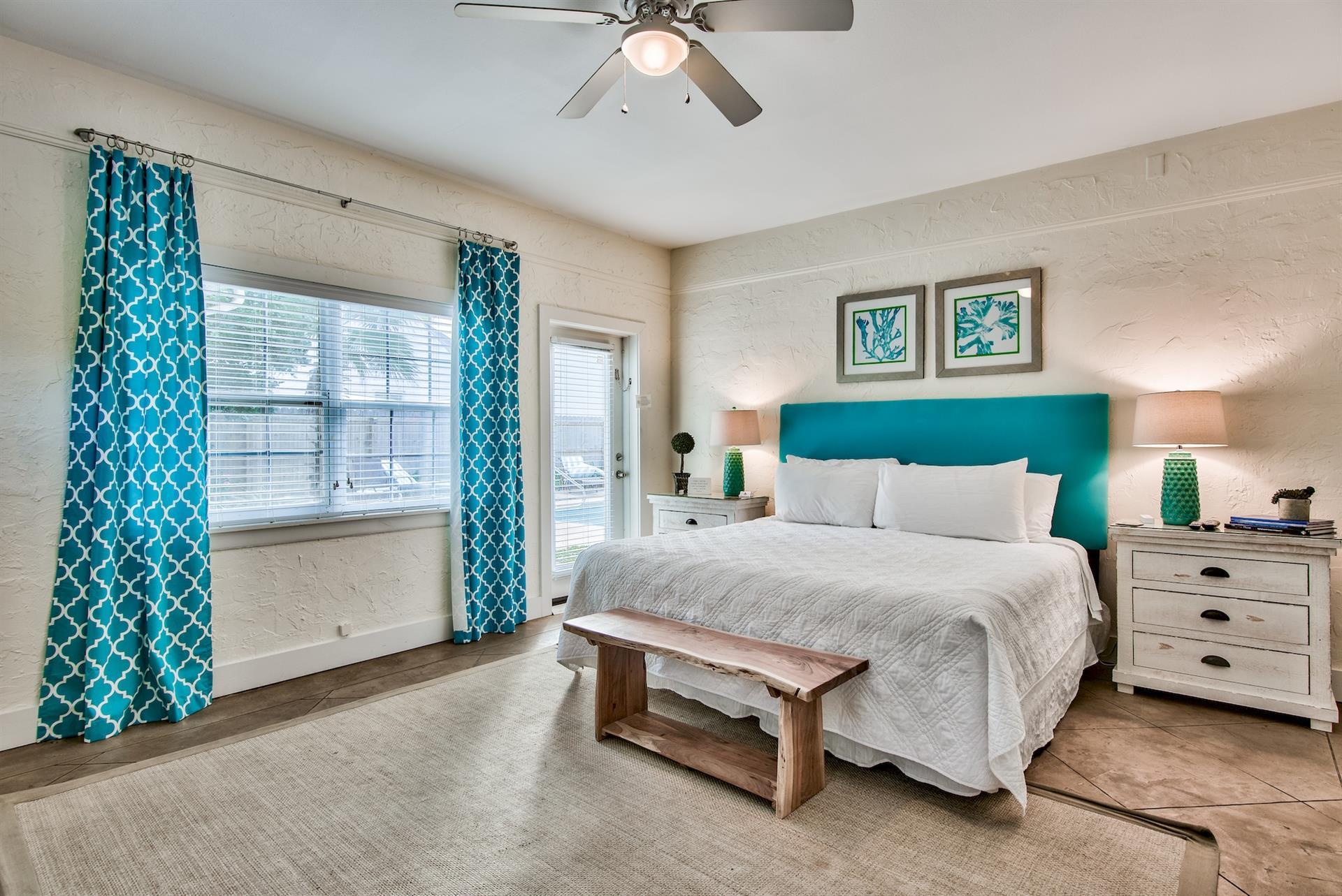 3rd Bedroom is the primary suite on the east end with a king bed, 45 TV,  walkin closet, ensuite full bathroom with a bathtubshower combination, and views of the pool area  door leading out to the pool.  safety alarm on door