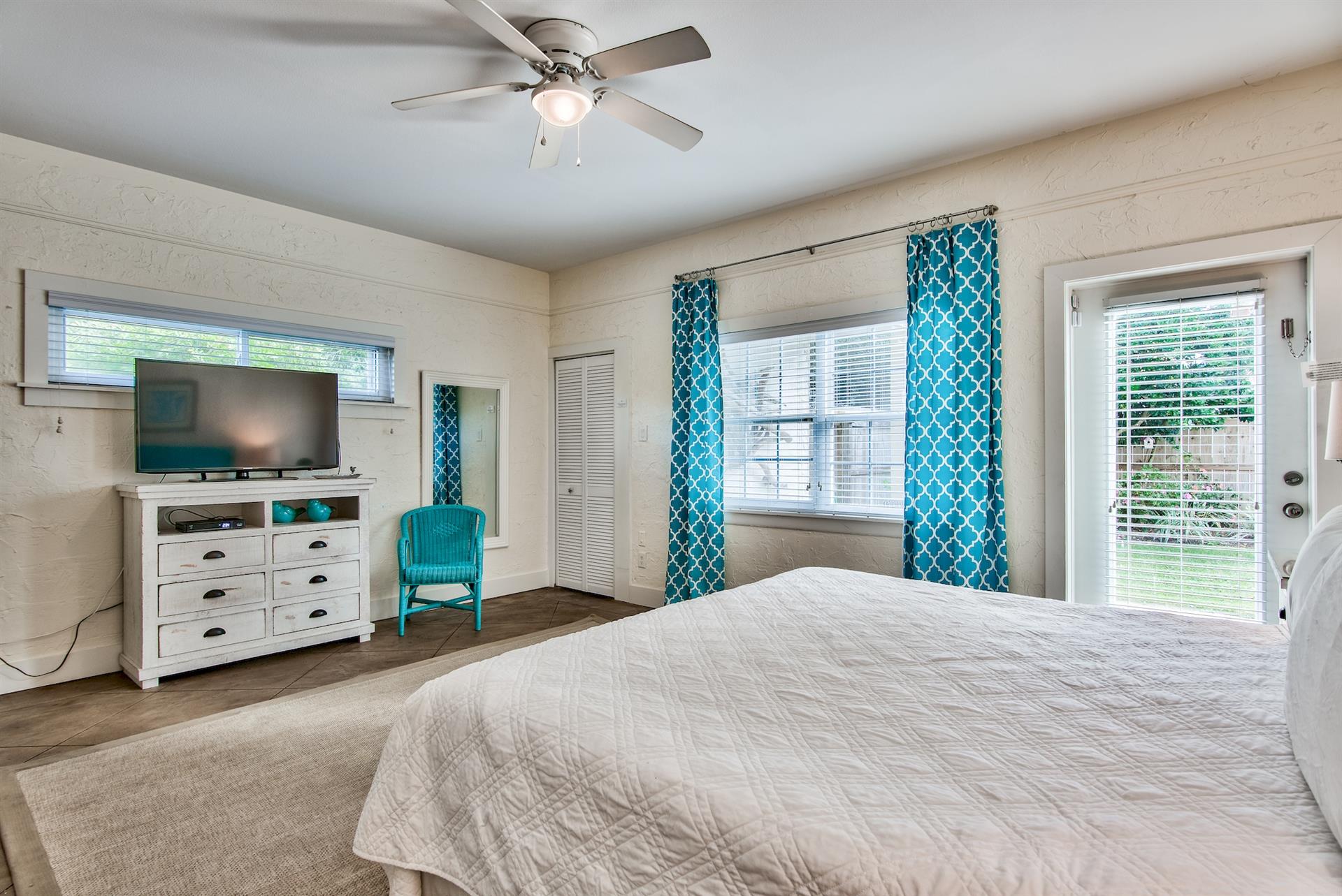 3rd Bedroom is the primary suite on the east end with a king bed, 45 TV,  walkin closet, ensuite full bathroom with a bathtubshower combination, and views of the pool area  door leading out to the pool.  safety alarm on door