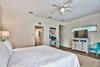 3rd Bedroom is the primary suite on the east end with a king bed, 45 TV,  walkin closet, ensuite full bathroom with a bathtubshower combination, and views of the pool area  door leading out to the pool.  safety alarm on door