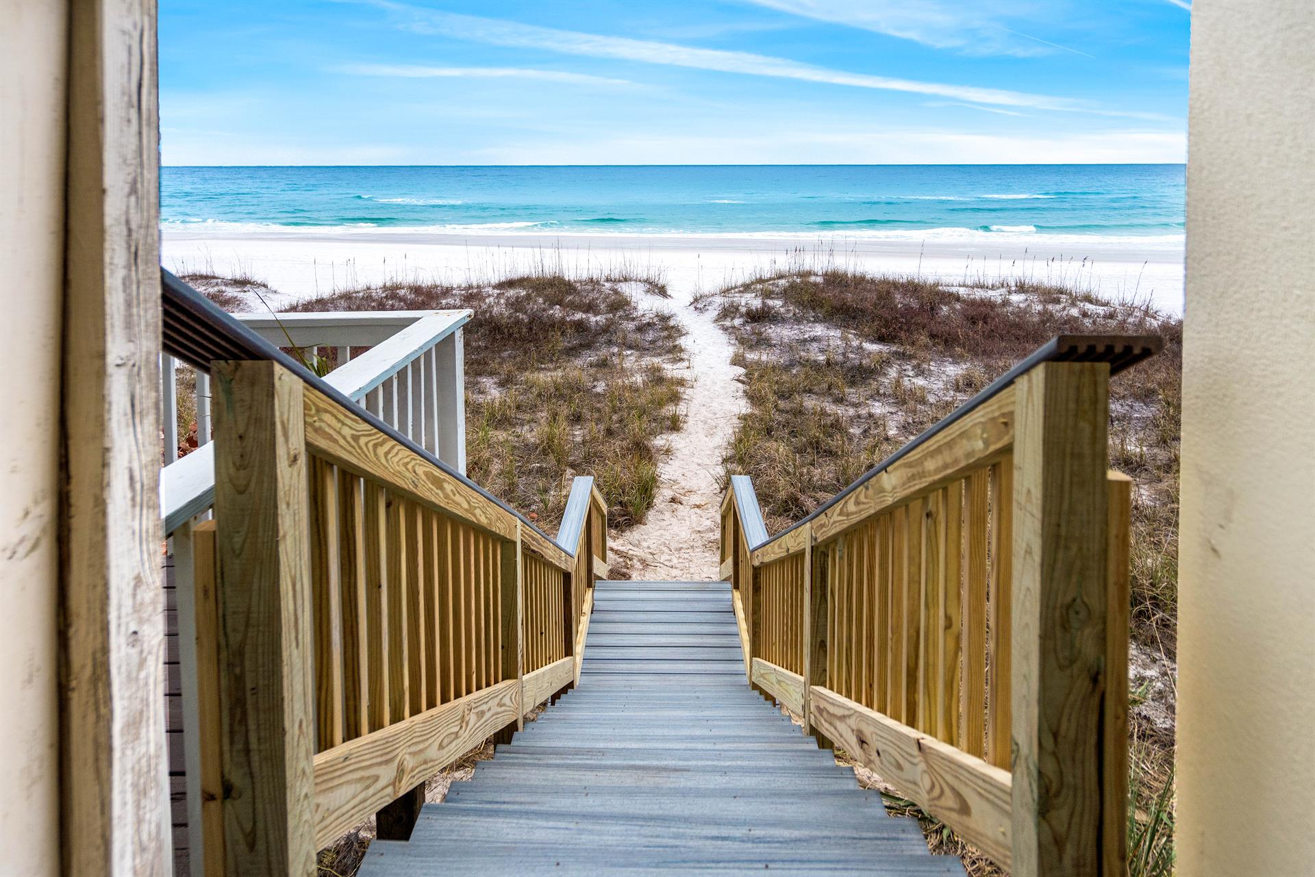 Steps down to the beach from the pool area