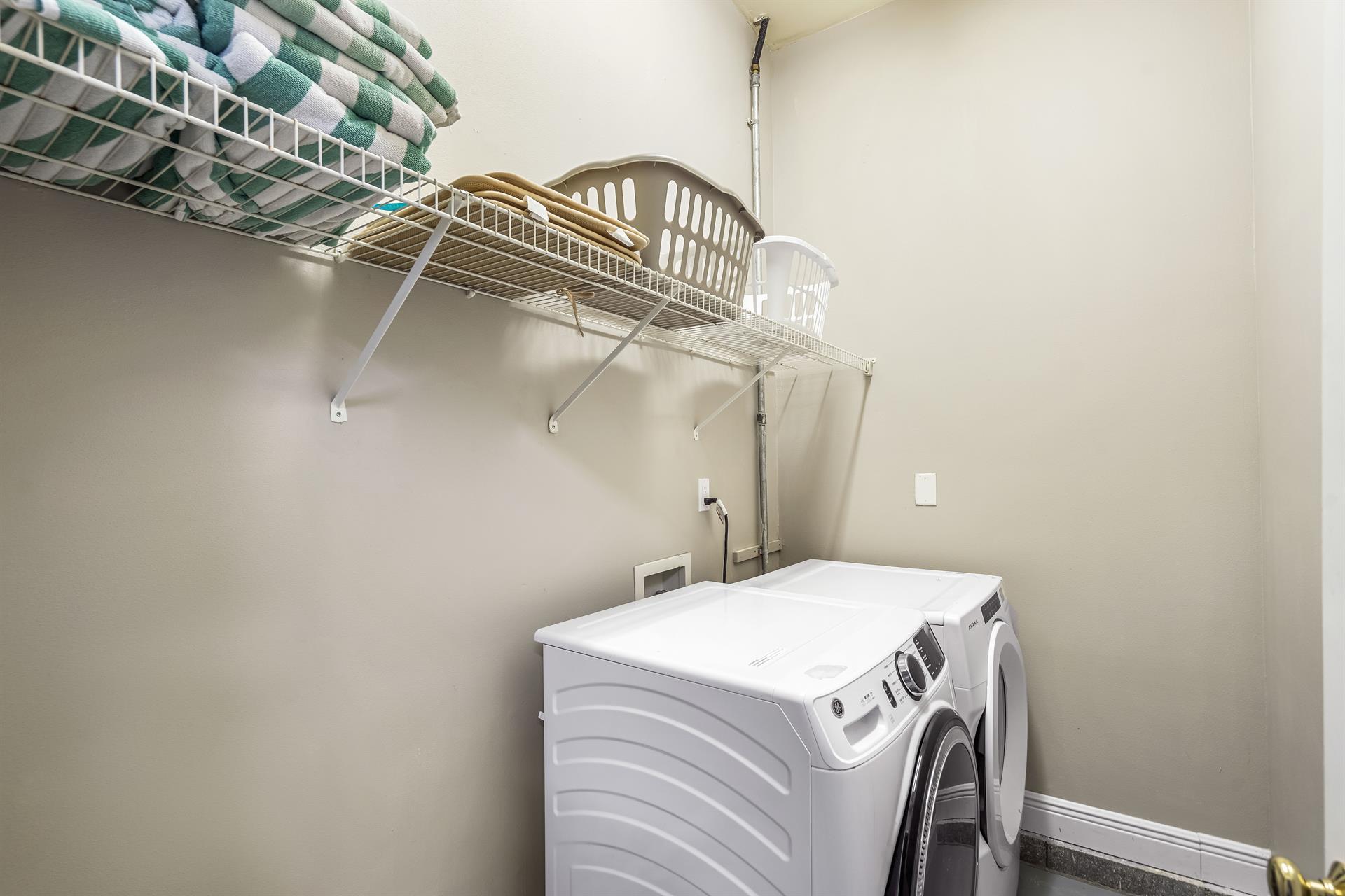 Laundry Room with full size washer and dryer located in separate room off the garage.  Beach Towels are stored here