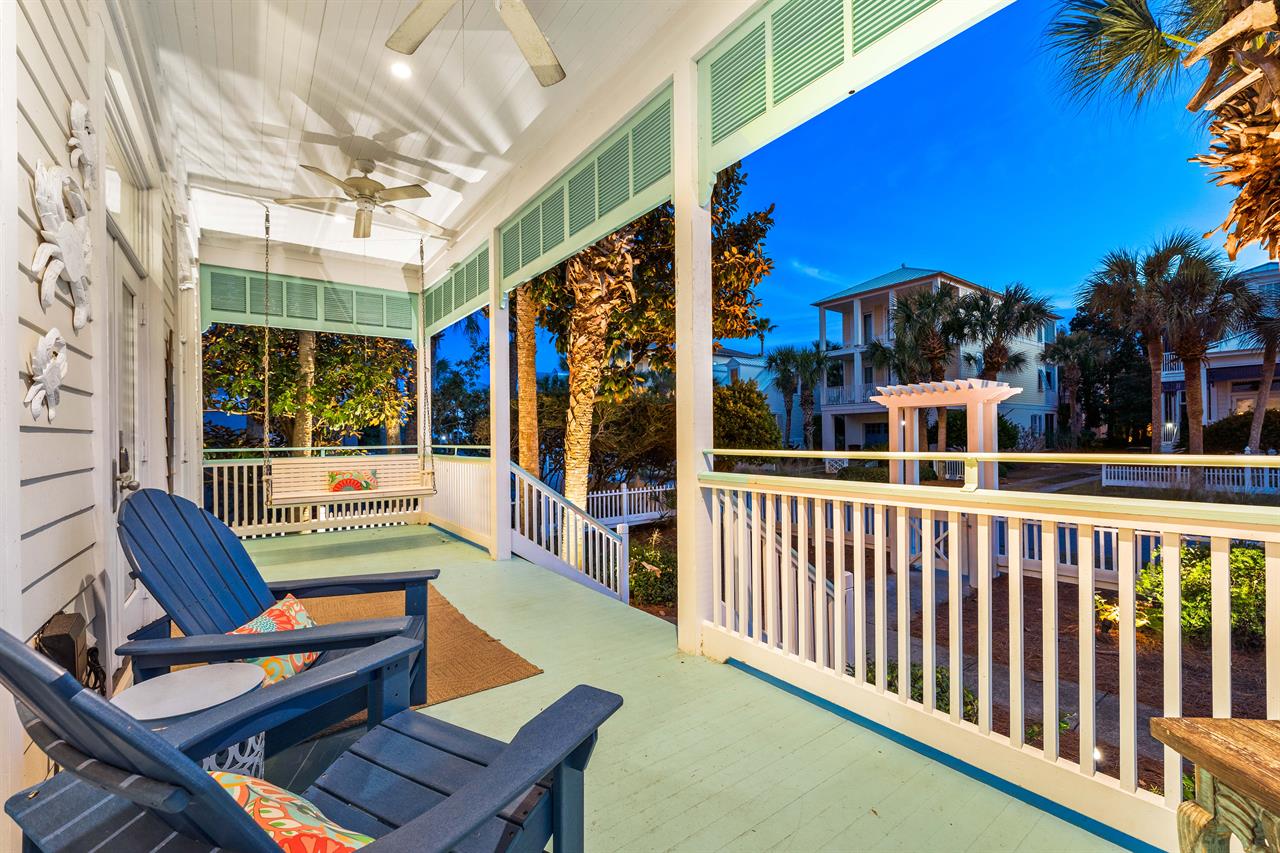 This colorful Old Florida front porch provides a welcoming entrance and a sense of nostalgia. Evenings spent on the porch bring lasting memories