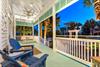 This colorful Old Florida front porch provides a welcoming entrance and a sense of nostalgia. Evenings spent on the porch bring lasting memories