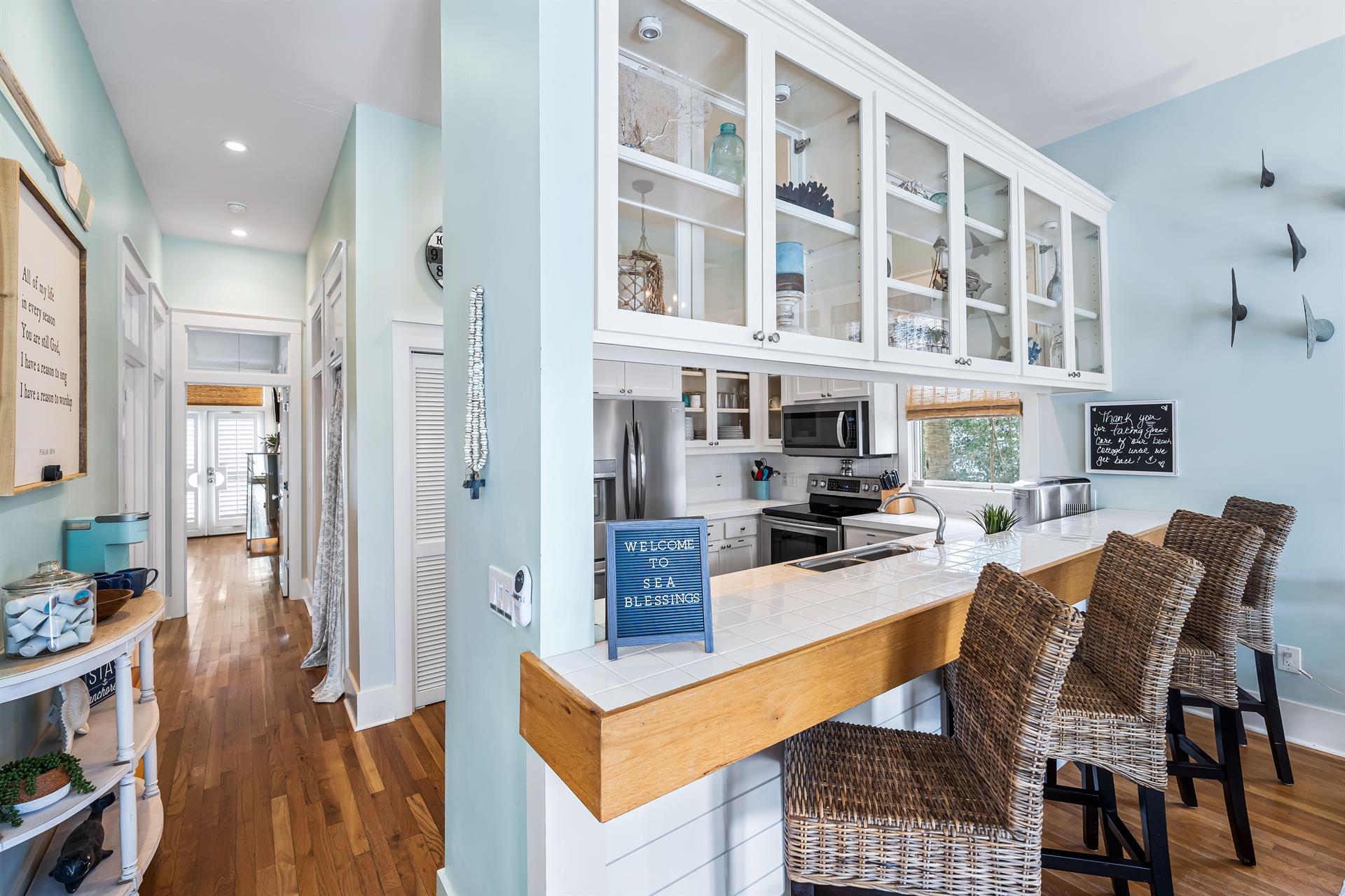 Custom cabinetry and a fully stocked kitchen with  a breakfast bar