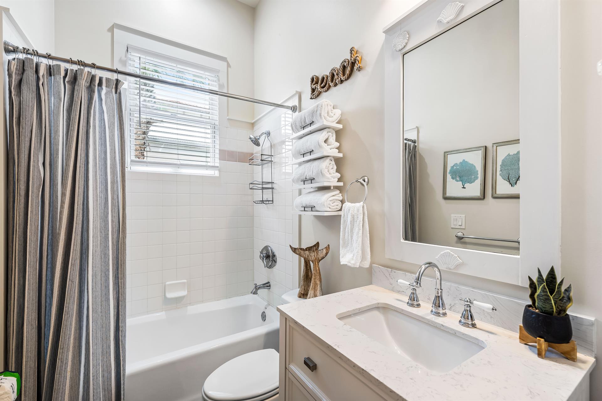 Full bathroom off the bunk bedroom with additional access from the hallway.  Linen closet stores your green  white beach towels.
