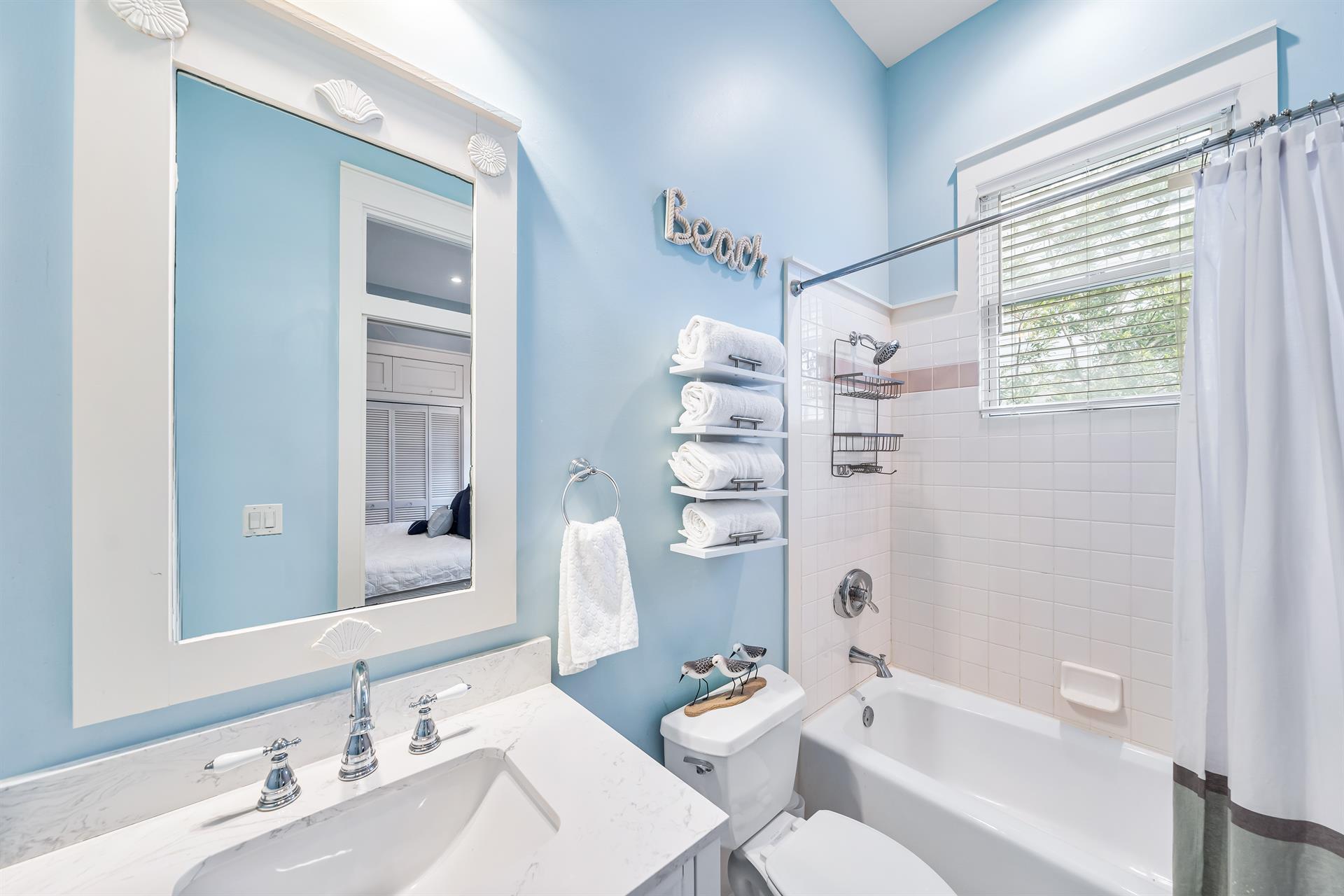 This king bedroom en suite  bathroom has a bathtub and shower combination.