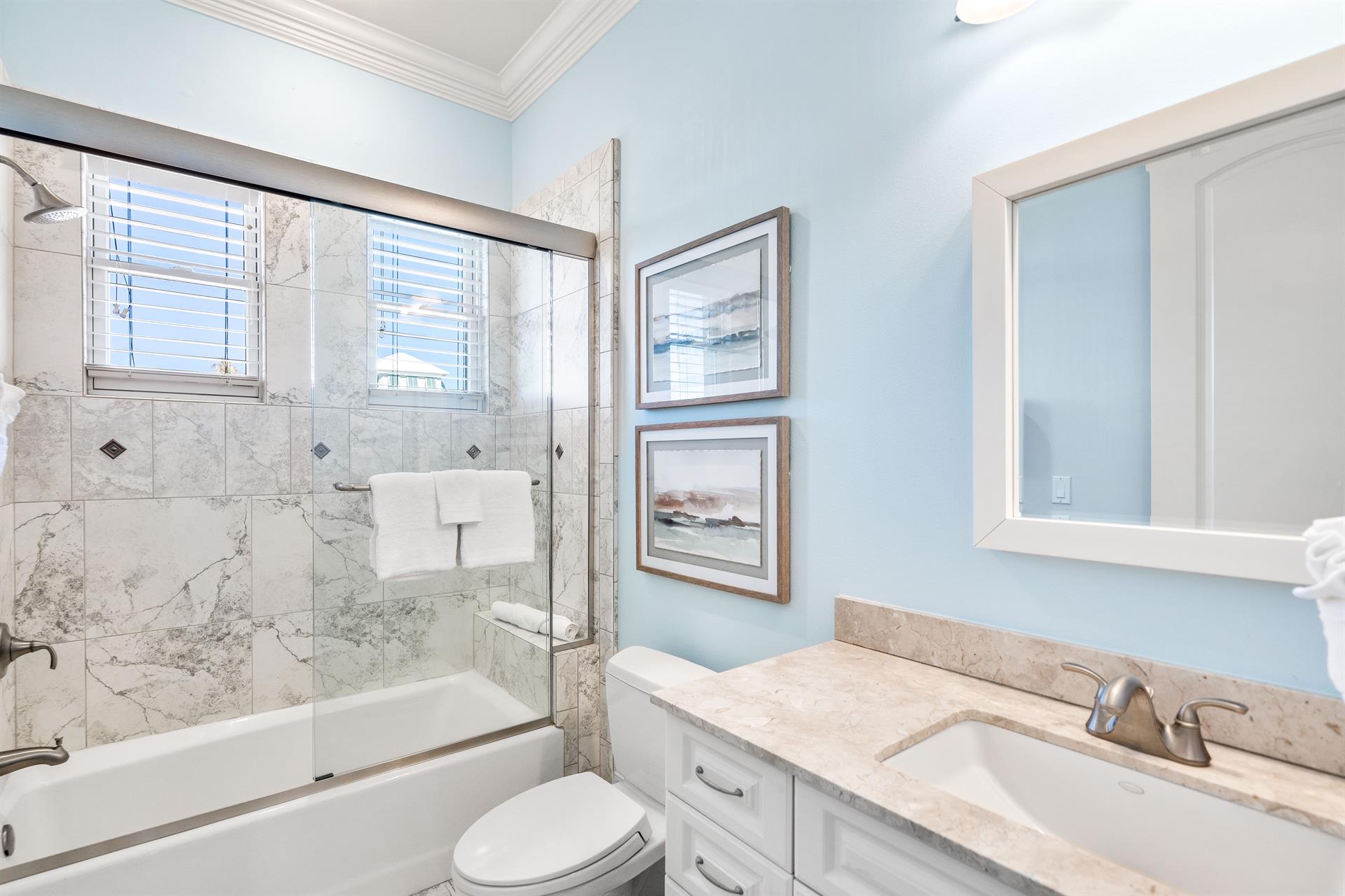 Third floor ensuite bathroom for the guest king bedroom with a bathtubshower combination.