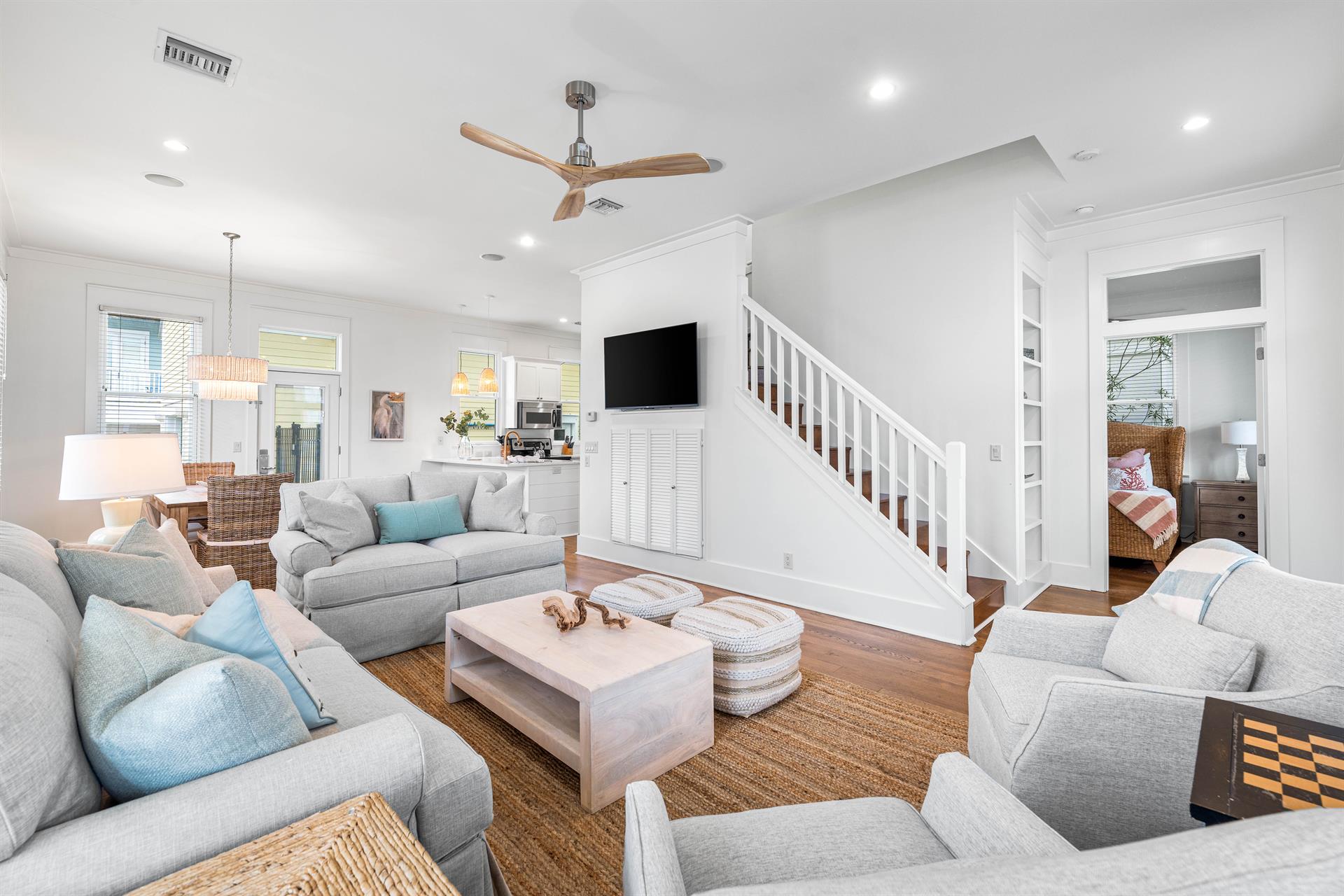 Newly refurbished great room with sisal rug, hardwood floors, shiplap accents  55 smart tv with YouTube.