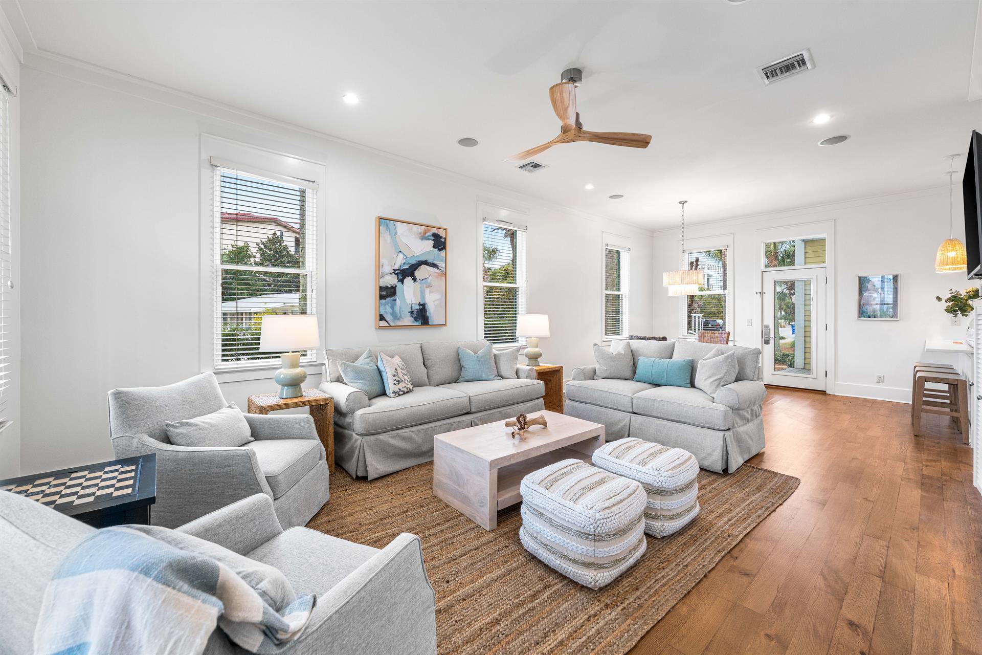 Newly refurbished great room with sisal rug, hardwood floors, shiplap accents  55 smart tv with YouTube.