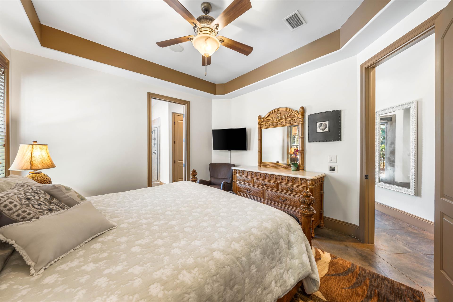 First floor king bedroom with a tray ceiling.