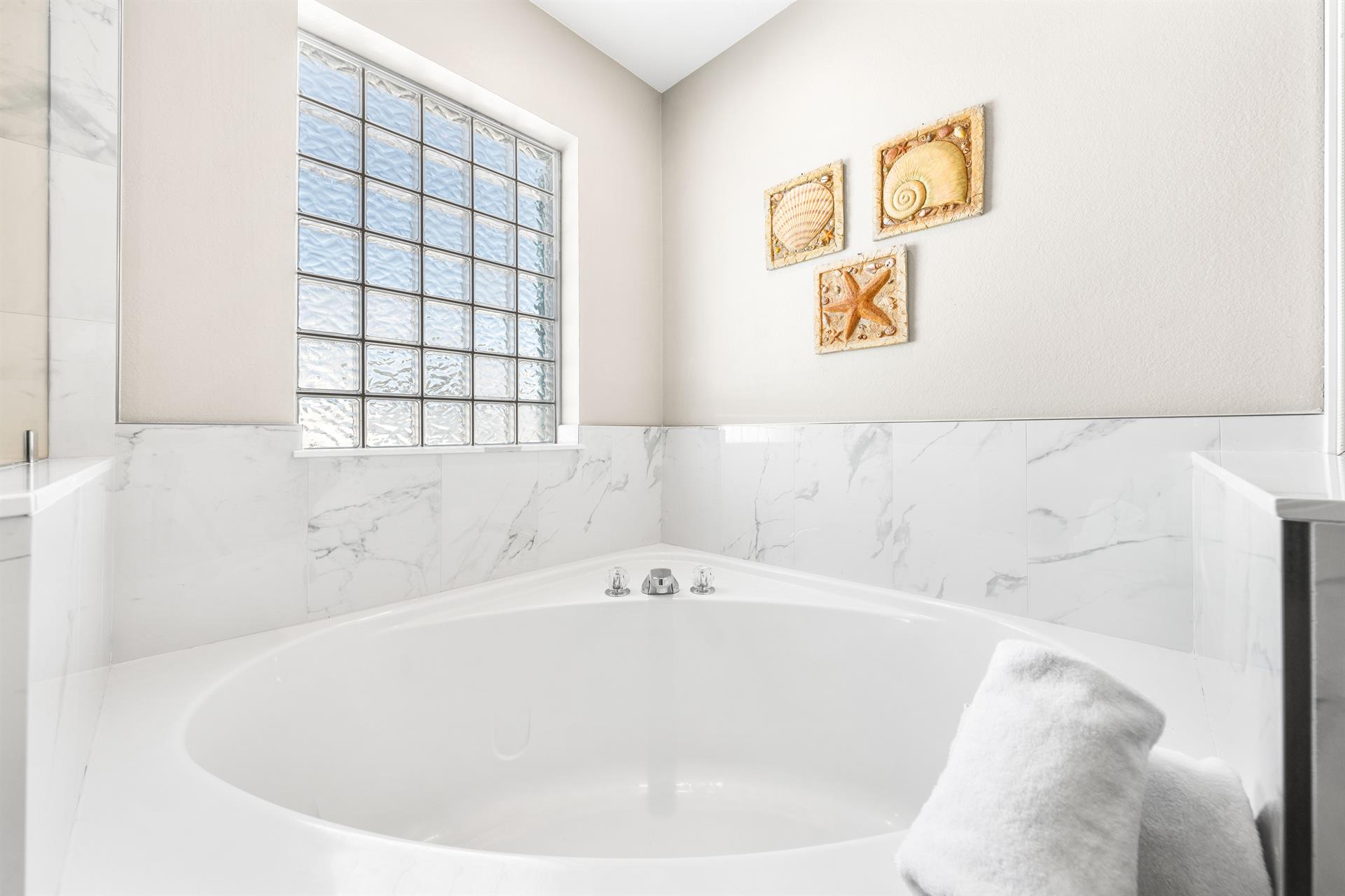 Large soaking tub in this primary ensuite bathroom.