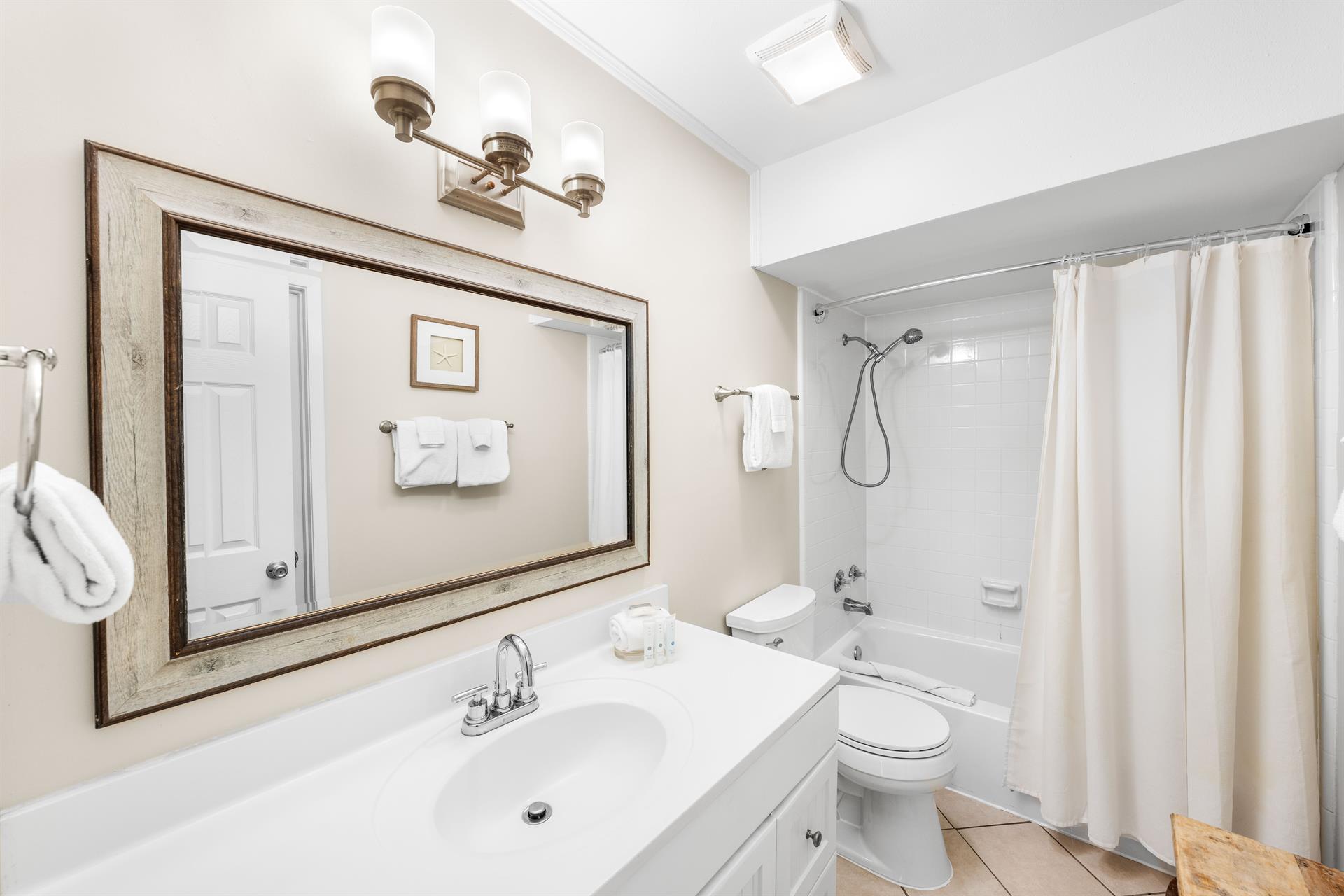 Freshen up in style Shower and tub combo in this upstairs bath with access from the hall and the double queen bedroom.