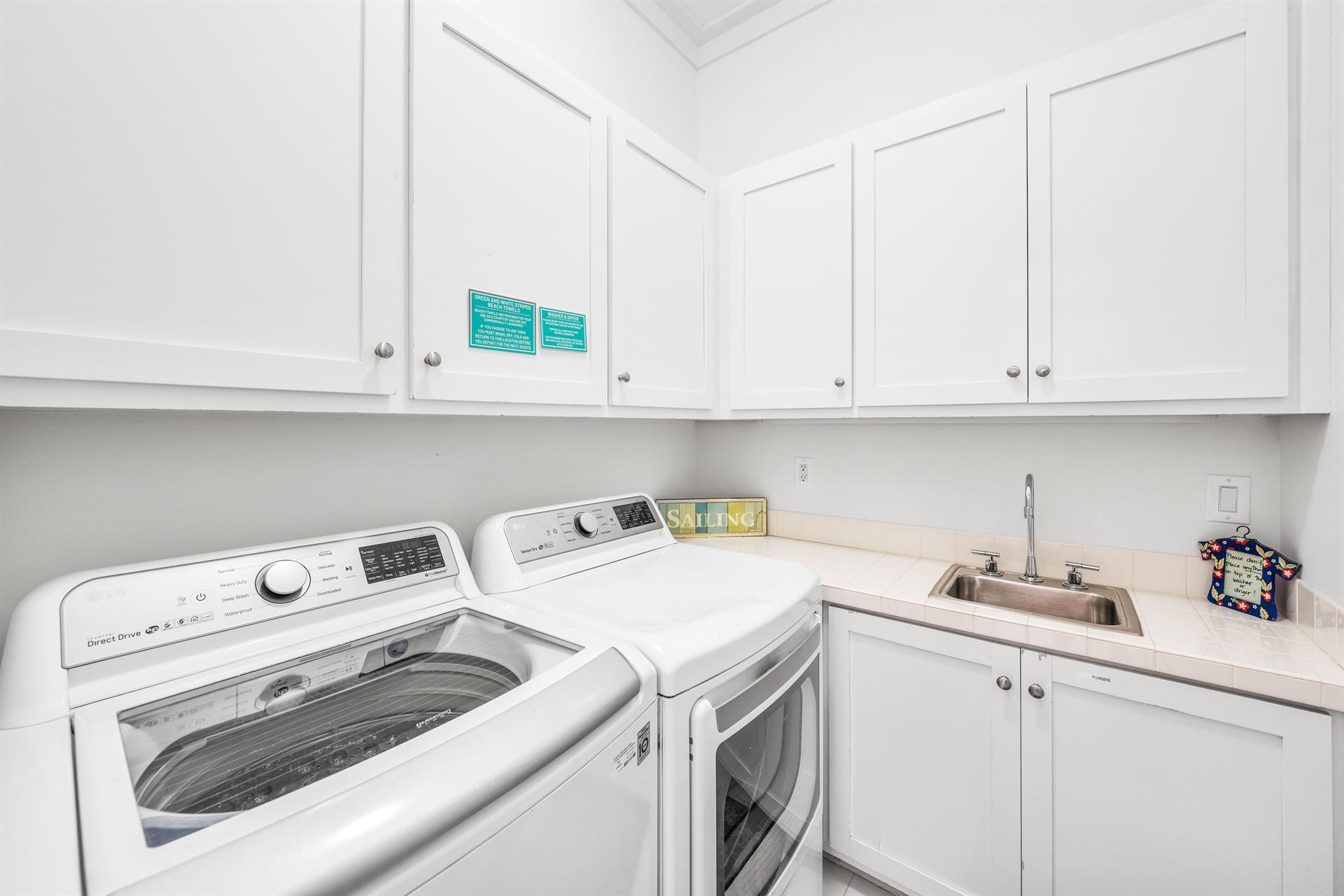This laundry room with full sized washerdryer, laundry detergent  dryer sheets has got your beach day cleanup covered