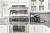 Advantium microwaveconvection oven with an electric oven and warming drawer below.  Double the food and double the fun.