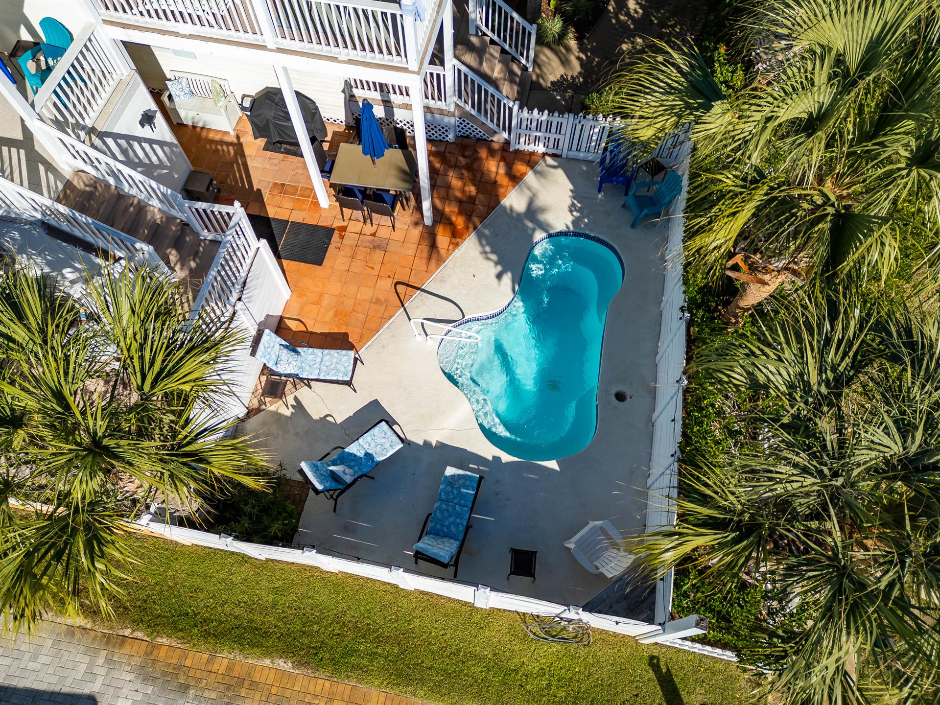Large Fenced In Pool Area with  seating and gas grill