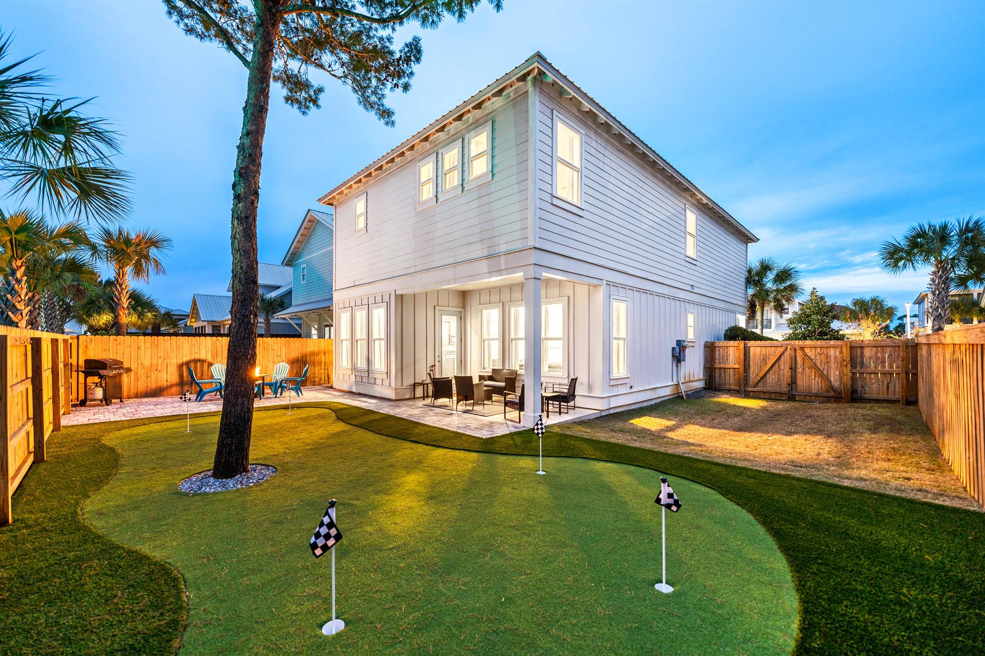 Relaxing fire pit with seating, propane grill, completely fenced in, large 5 hole putting green, putters  balls included, covered back porch with plenty of seating.