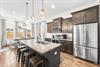 Cook like a chef in this fully stocked kitchen with KitchenAid stainless steel appliances, granite countertops,  island seating for 4