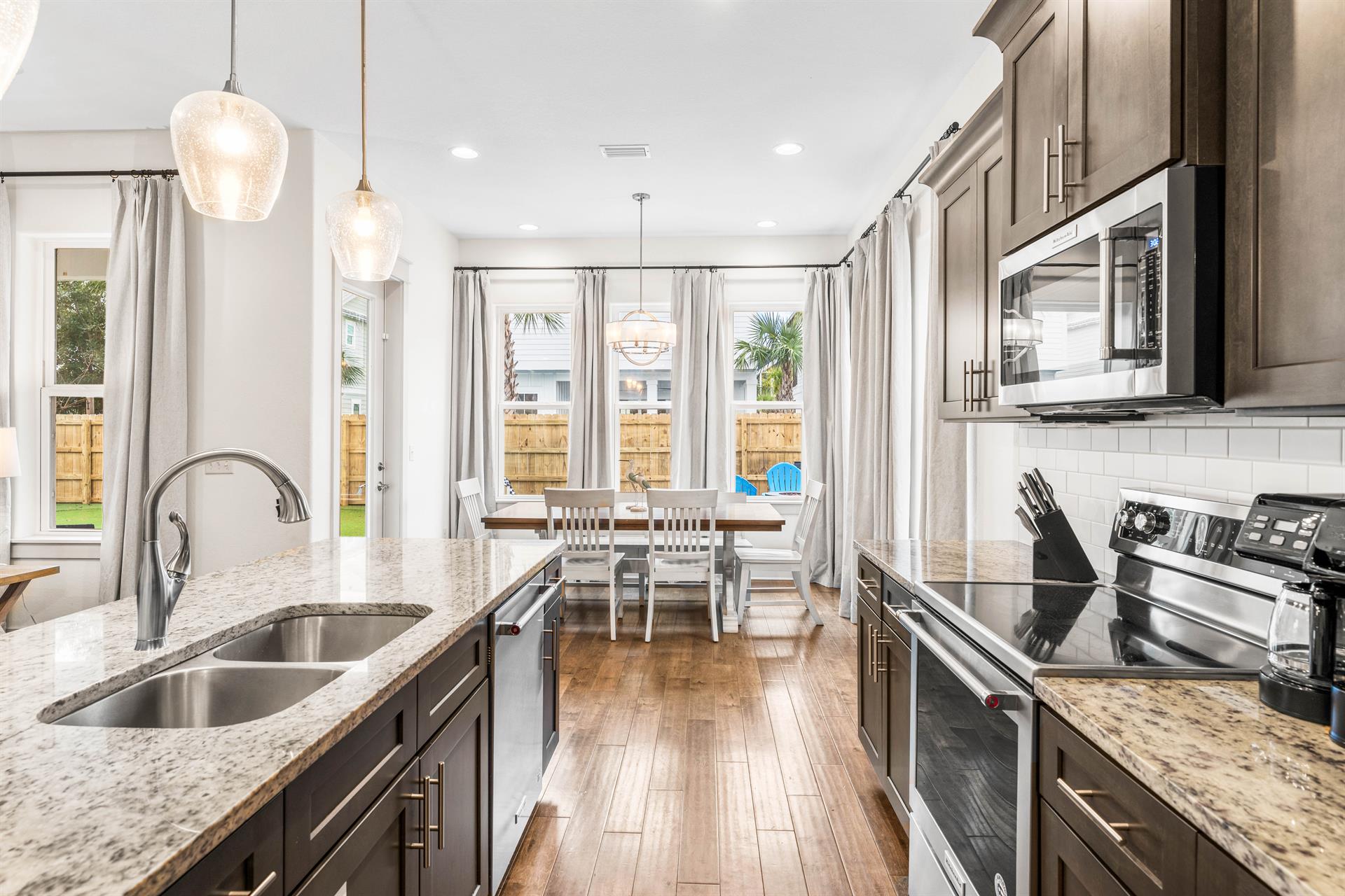 Beautiful countertops with pendant lighting for the kitchen island childs high chair located in the kitchen pantry closet