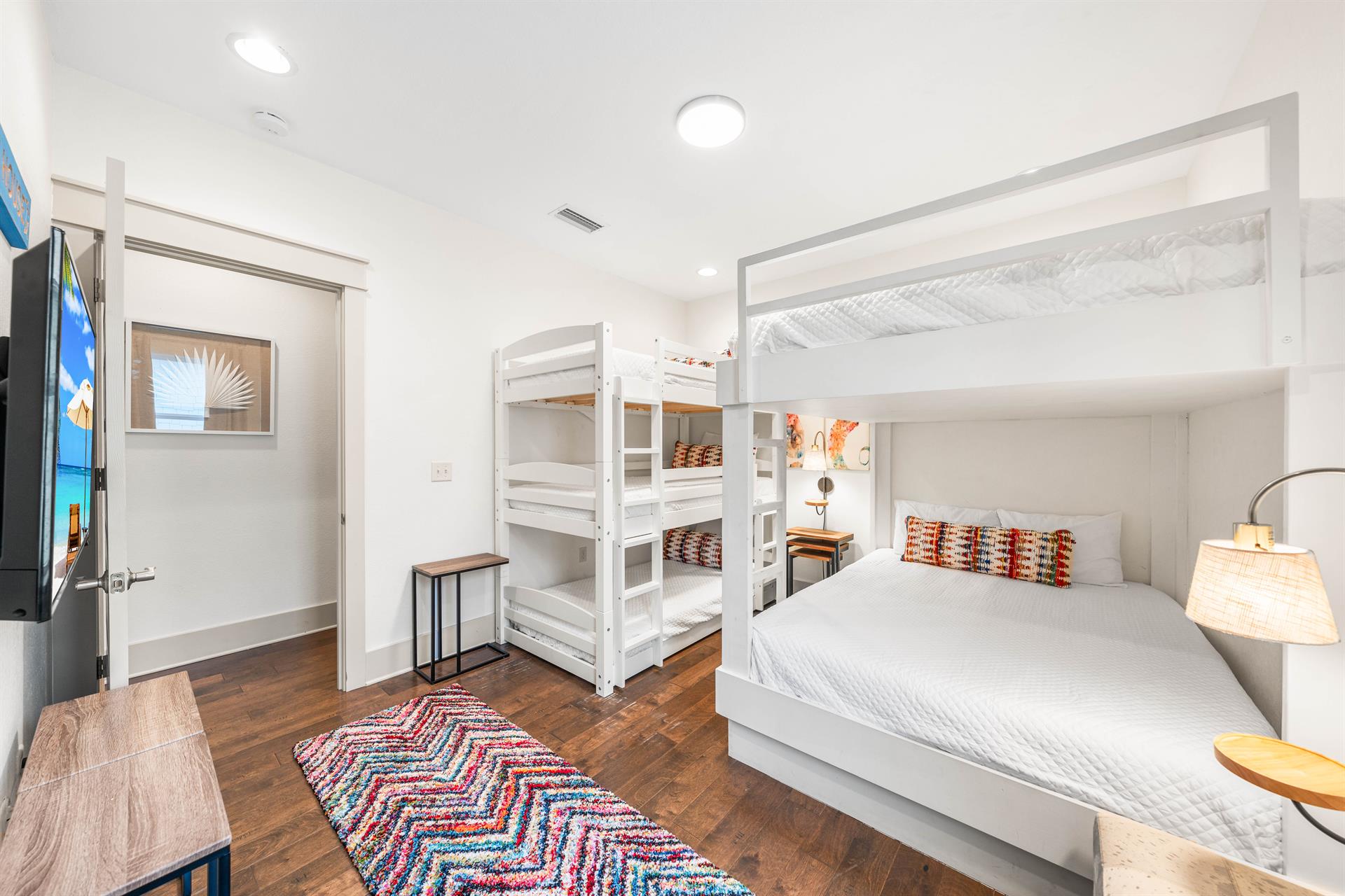 Colorful accents in this 2nd floor bunk bedroom with 3 twins  2 queens.