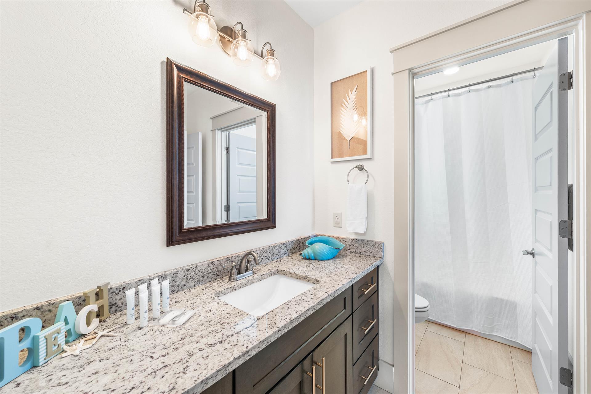 Full bathroom for the bunk bedroom with a bathtub  shower combination.  This bathroom is also accessible from the kids livinggame area.