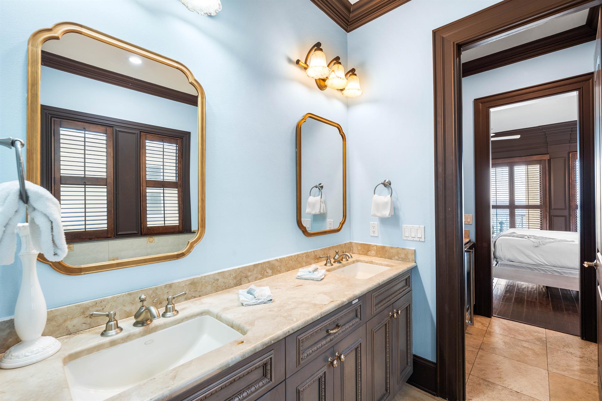 Double travertine vanities in this primary ensuite.