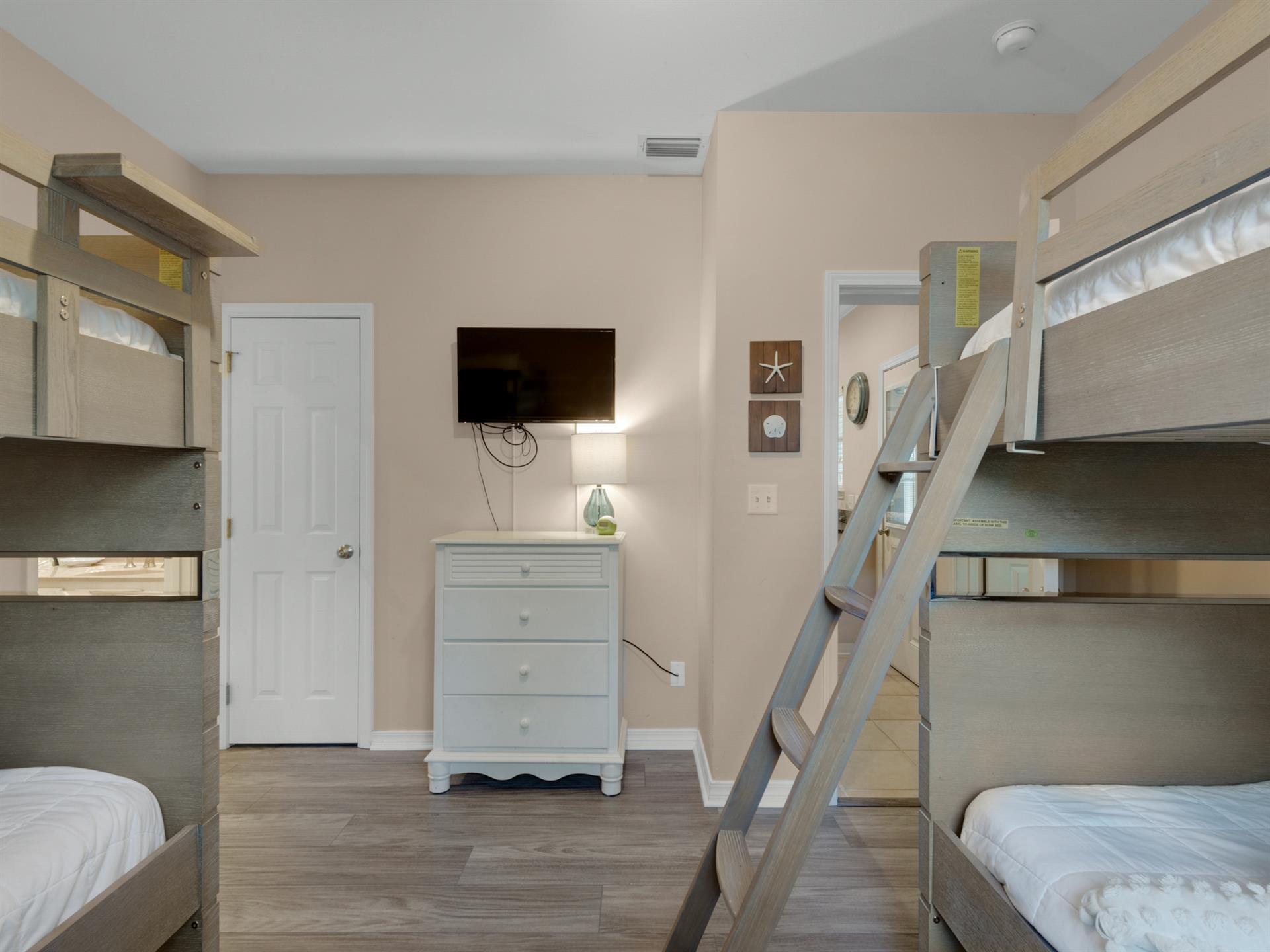 Bunk room with wall mounted TV