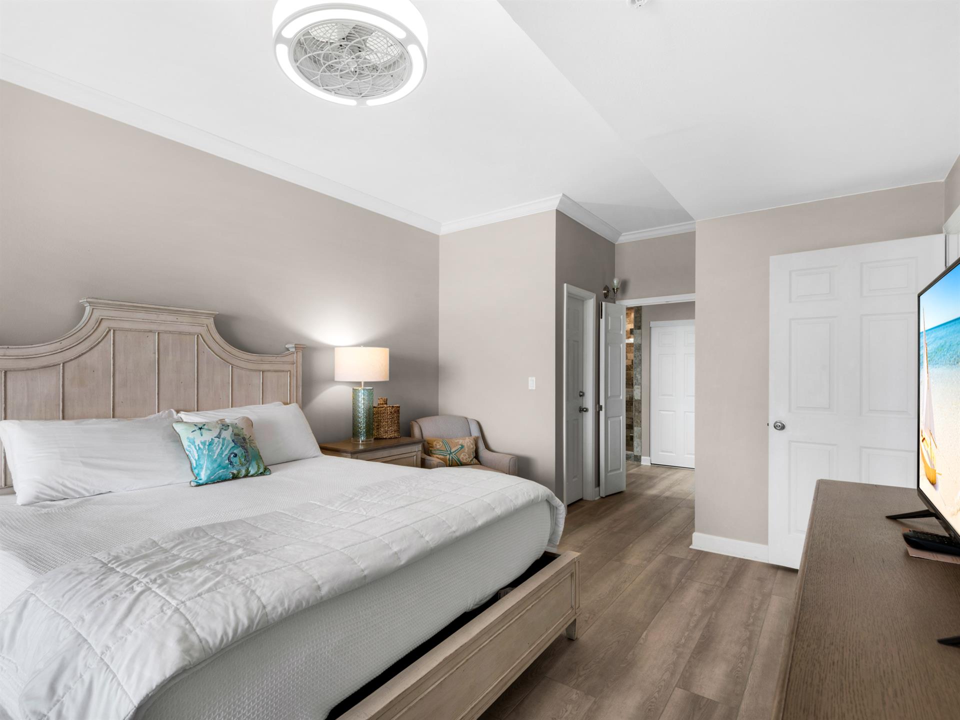 Primary bedroom TV and private full bath with walk in shower