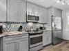 Stainless Steel Appliances, Custom Backsplash and Cabinets