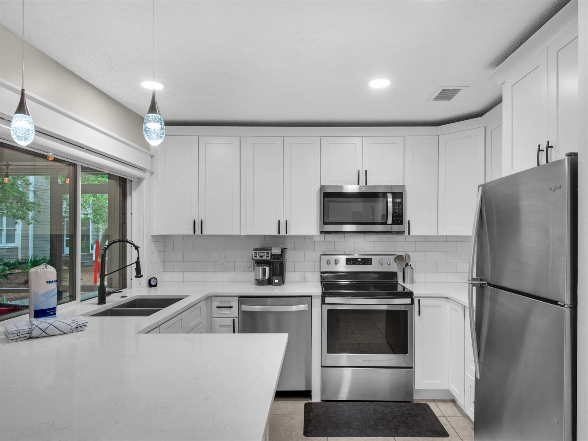 Fully Equipped Kitchen with Pass Through Window to Private Screened Balcony