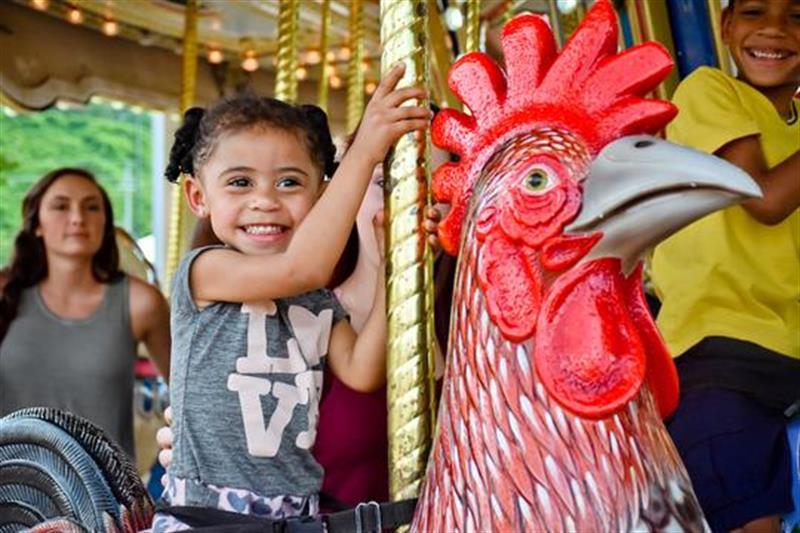 Toddler riding a ride at The Track