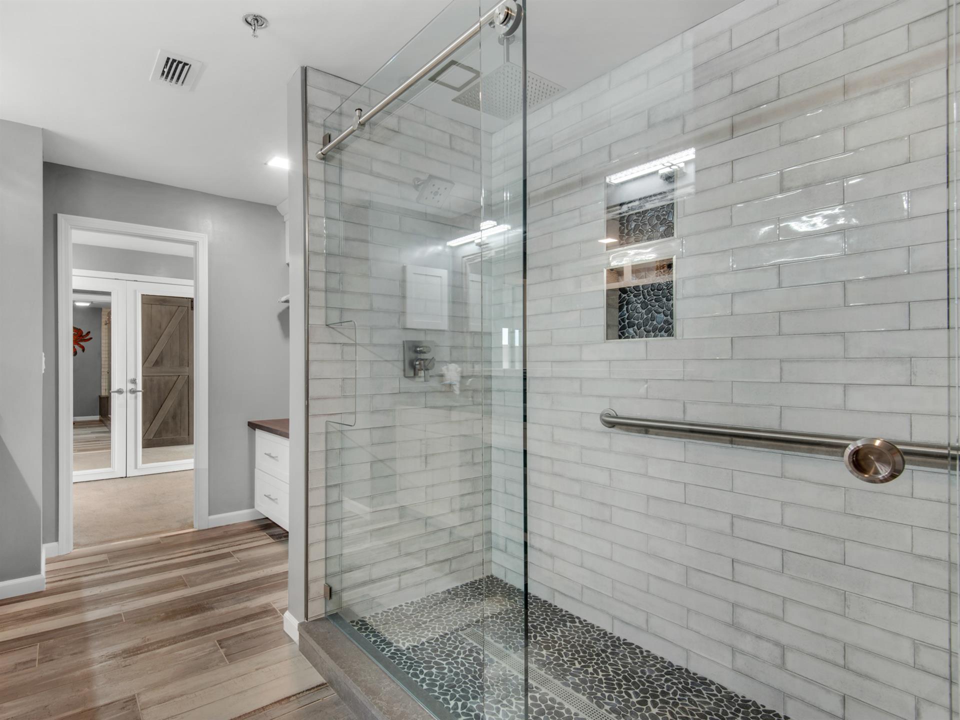 Double Walkin Shower with Dual Rainfall Showerheads in Primary Bathroom