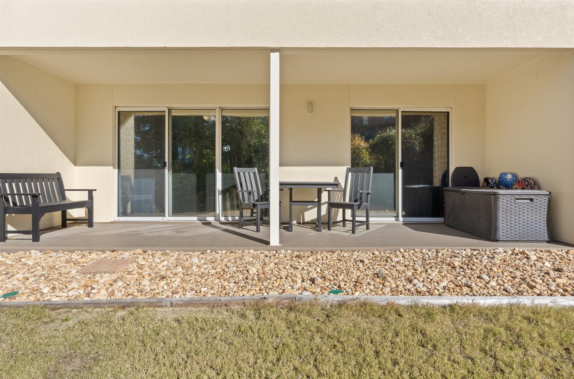 Large Patio Seating with Access from Primary Bedroom and Living Room  this grassy area is not a pet friendly area