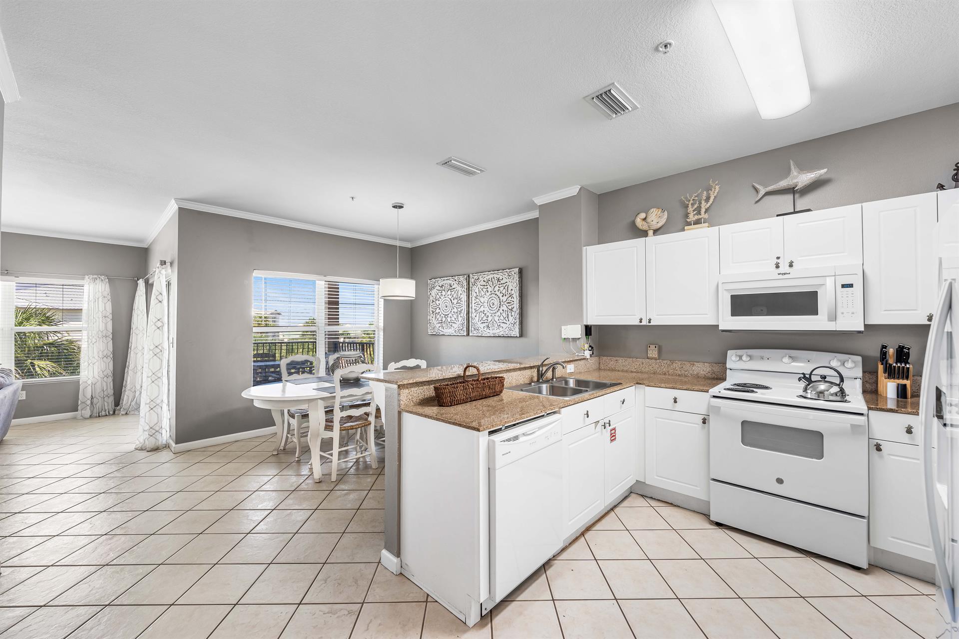 Fully Stocked Kitchen with Bar Seating for 3 and Dining Area
