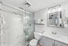 Newly renovated master bathroom with sleek vanity and spacious w
