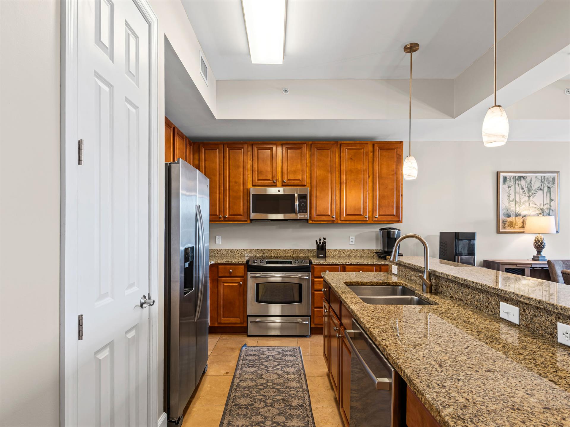Your spacious kitchen features granite countertops, stainless steel appliances, and plenty of cabinet space—perfect for preparing memorable meals during your stay.
