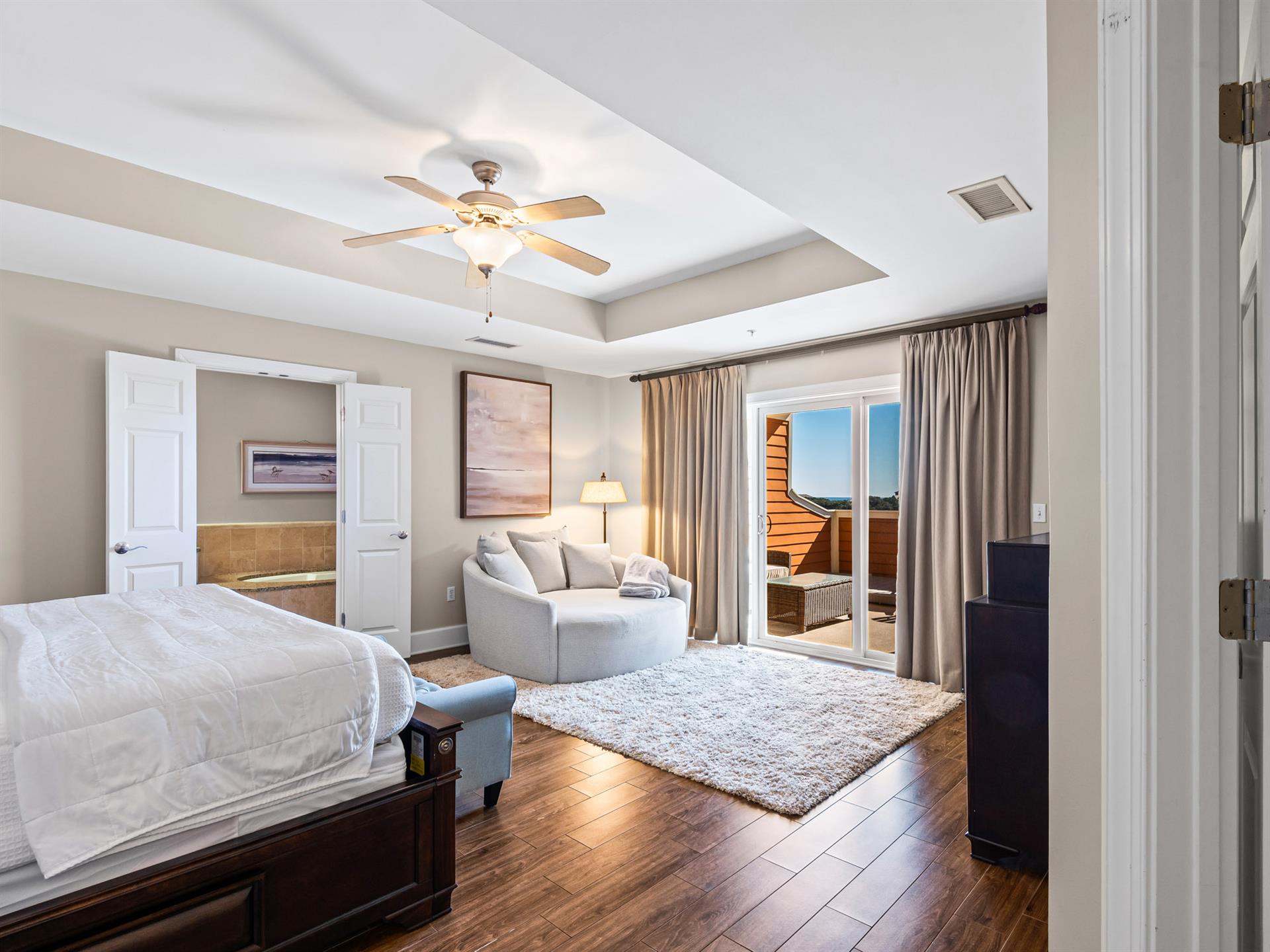 Bedroom 1 your primary suite offers elegant tray ceiling and private balcony access for peaceful moments.