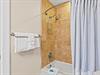 Bathroom 3 Step into your private bathroom featuring elegant stone tile and fresh towels ready for your arrival.